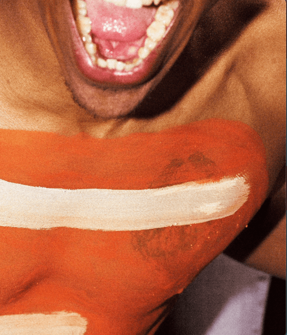 Close-up of excited fan with painted chest and open mouth, capturing raw energy and self-expression for Nike Be True March Madness out-of-home campaign.