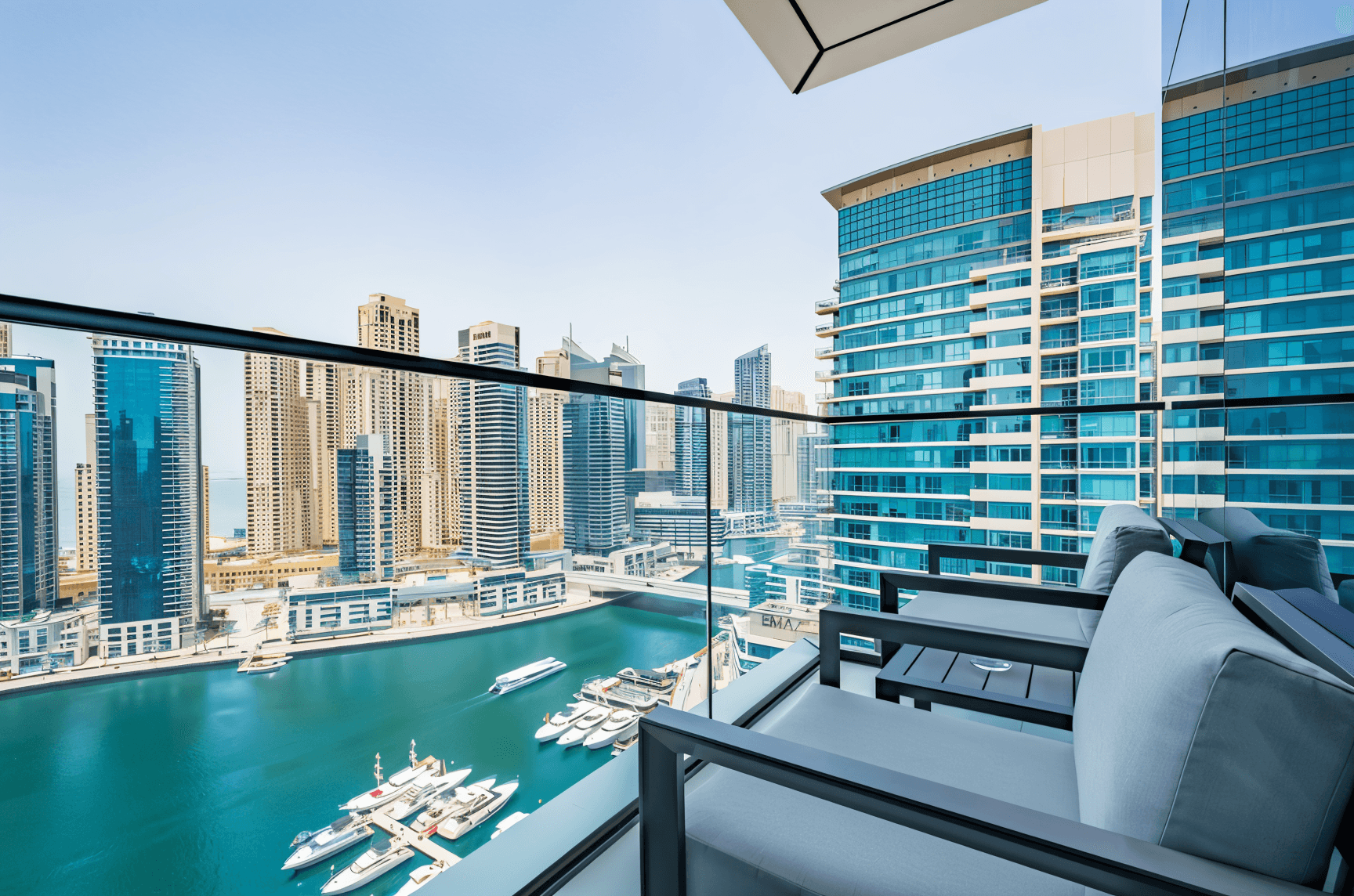 A balcony at Vida Dubai offers a stunning view of the marina, showcasing boats and the vibrant city skyline.