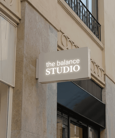 Minimal plant cutting with exposed roots in a clear glass bowl vase filled with water on a white background.