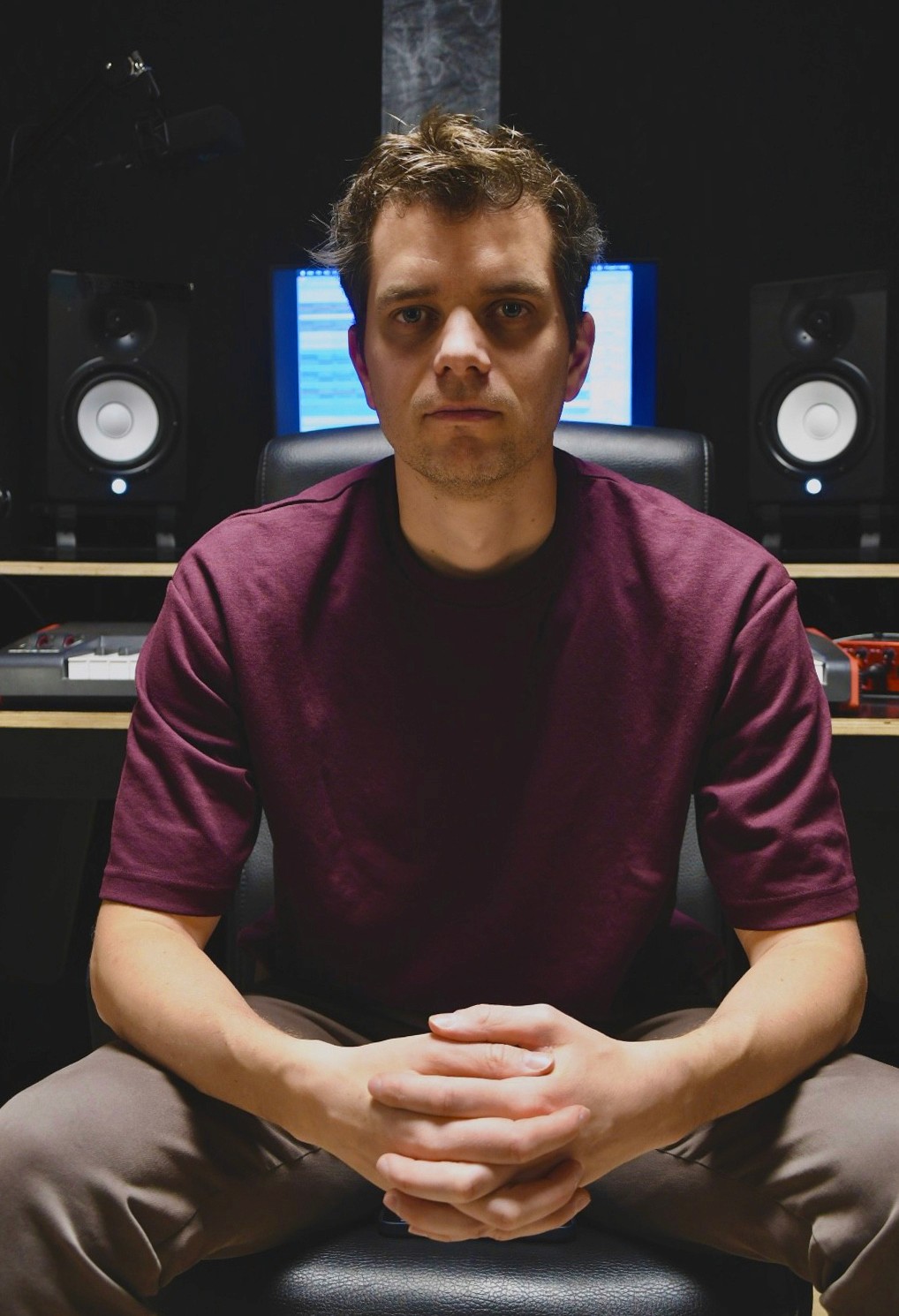 Music producer sitting in his studio