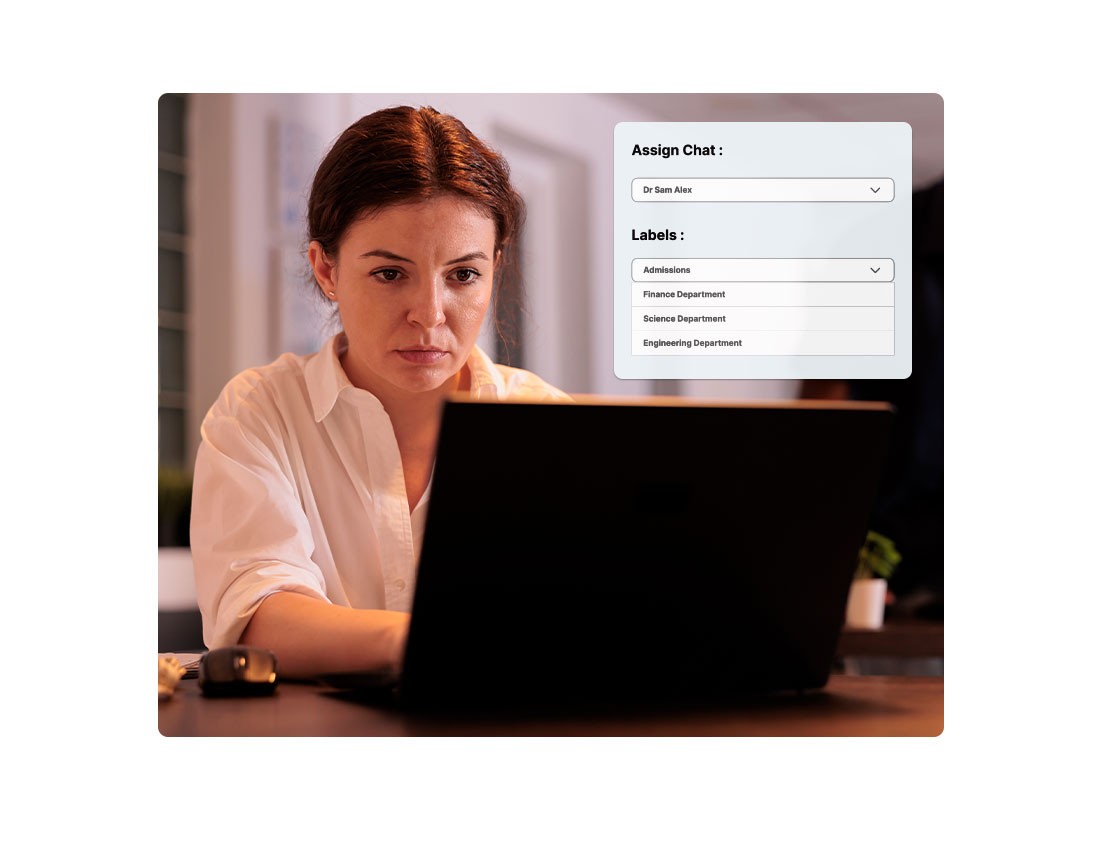 Professional woman working on a laptop in an office setting with a user interface displaying options to assign chat and select department labels, including Admissions, Finance, Science, and Engineering