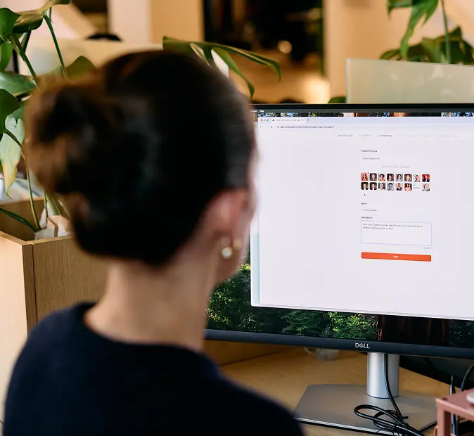 Photo of a woman looking ag monitor with Solidroad software open