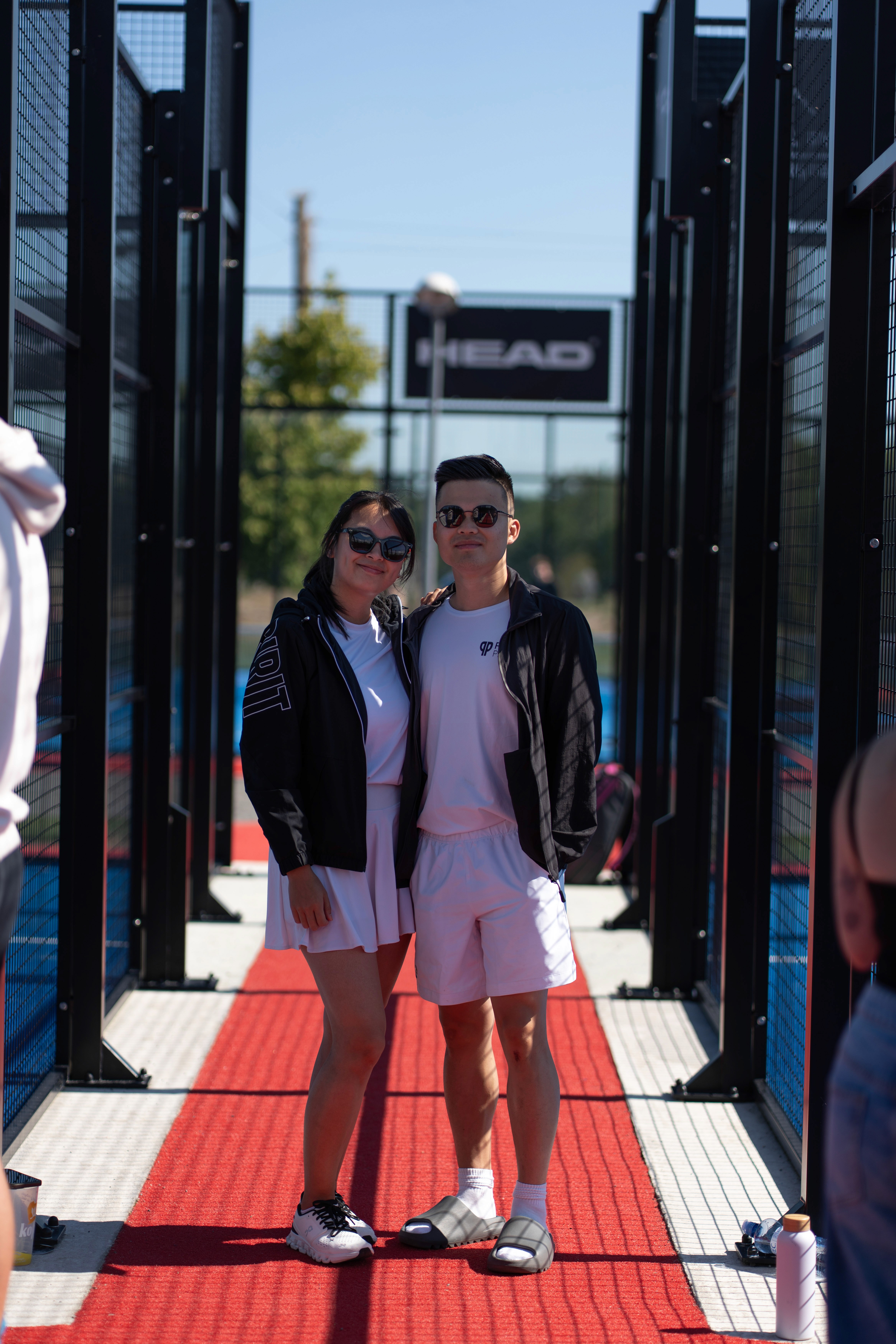 Close-up of two hands gently clasped, one wearing a sparkling engagement ring. The soft lighting and pastel nails evoke a sense of romance and intimacy.