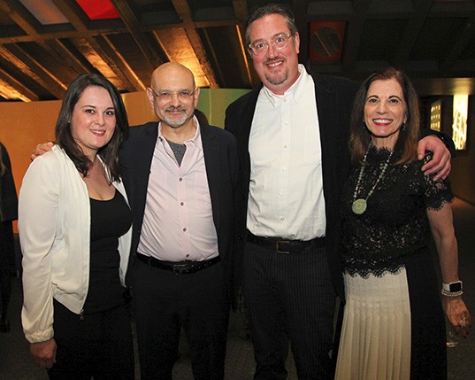 portrait of two men in the middle and two women on the left and the right