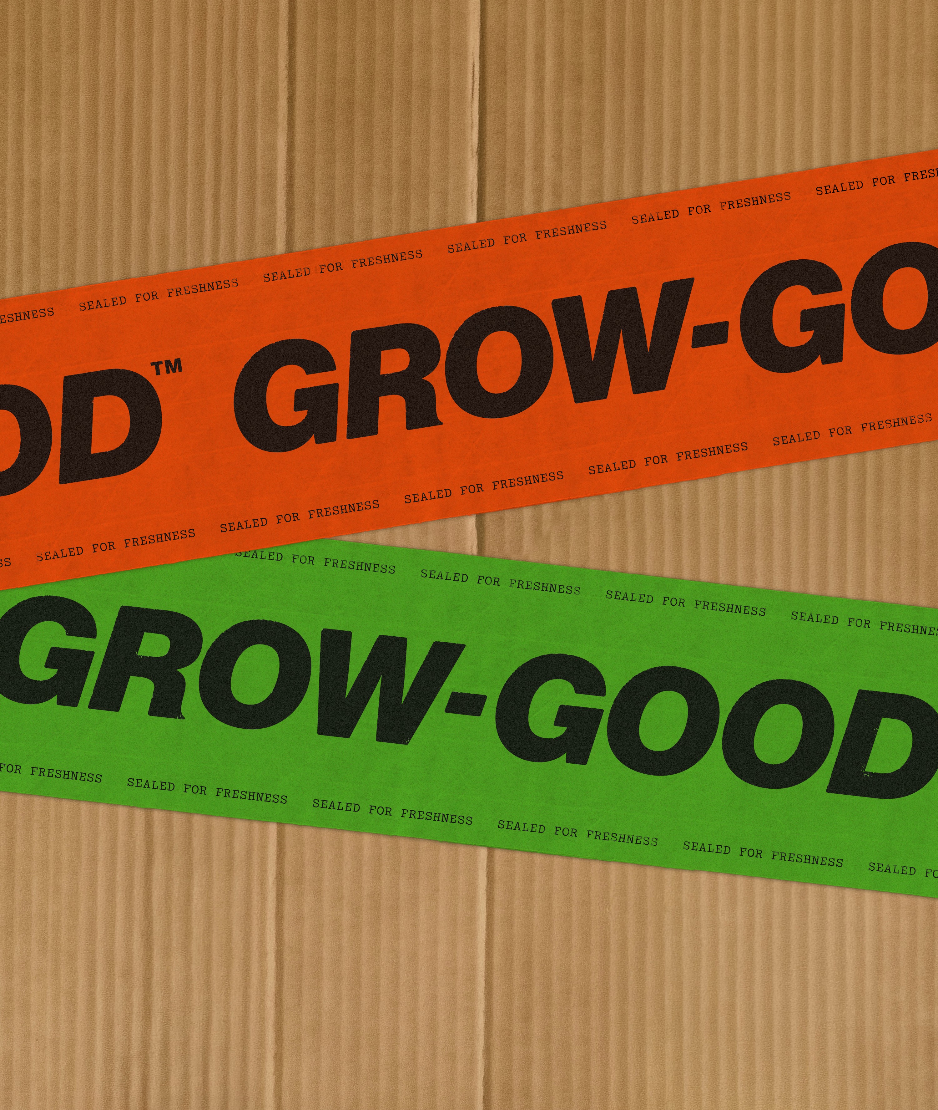 Grow-Good Beauty branded packaging tape on corrugated cardboard — repeating logotype in orange and black