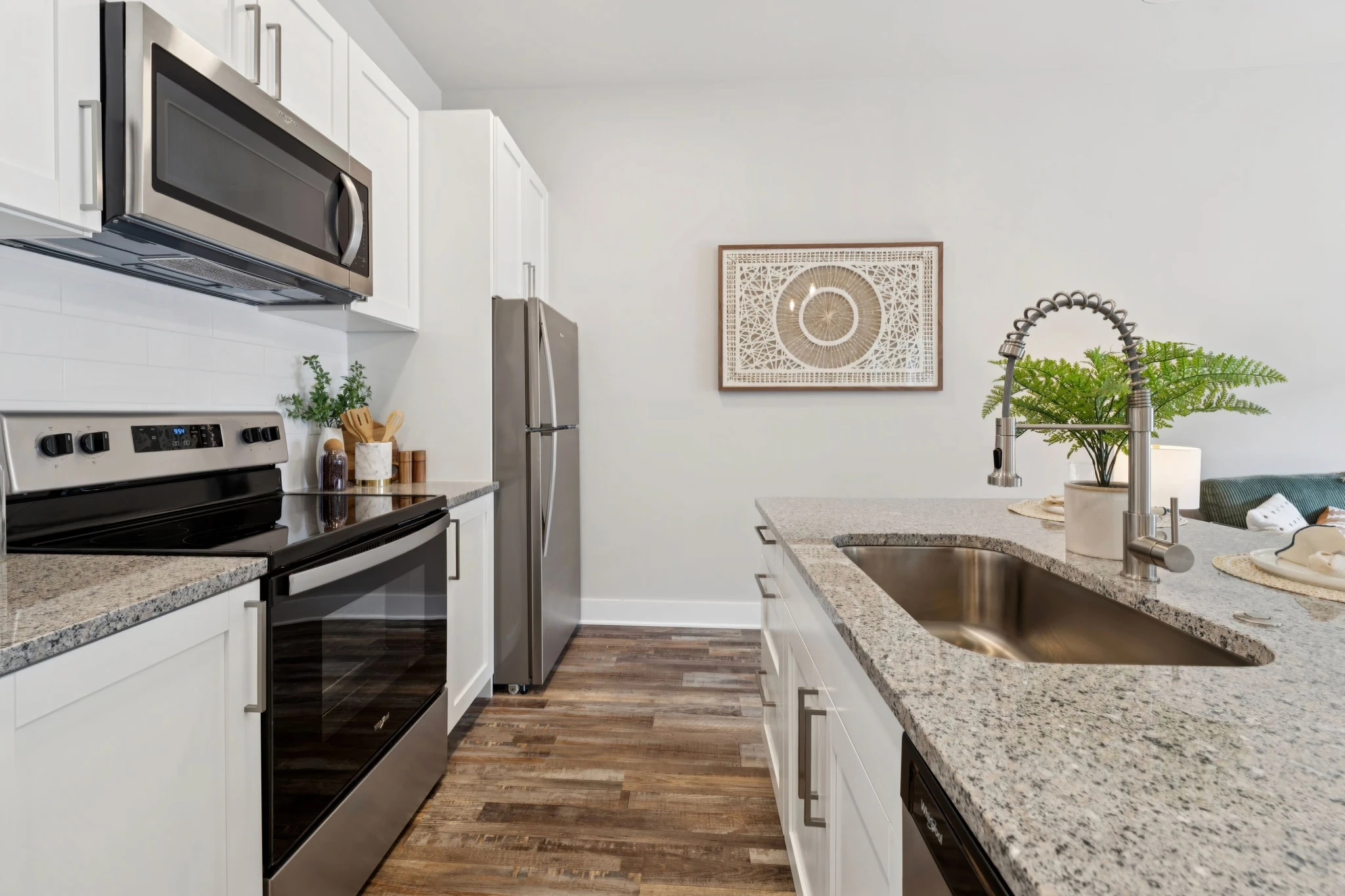 A modern kitchen featuring stainless steel appliances and elegant granite countertops.