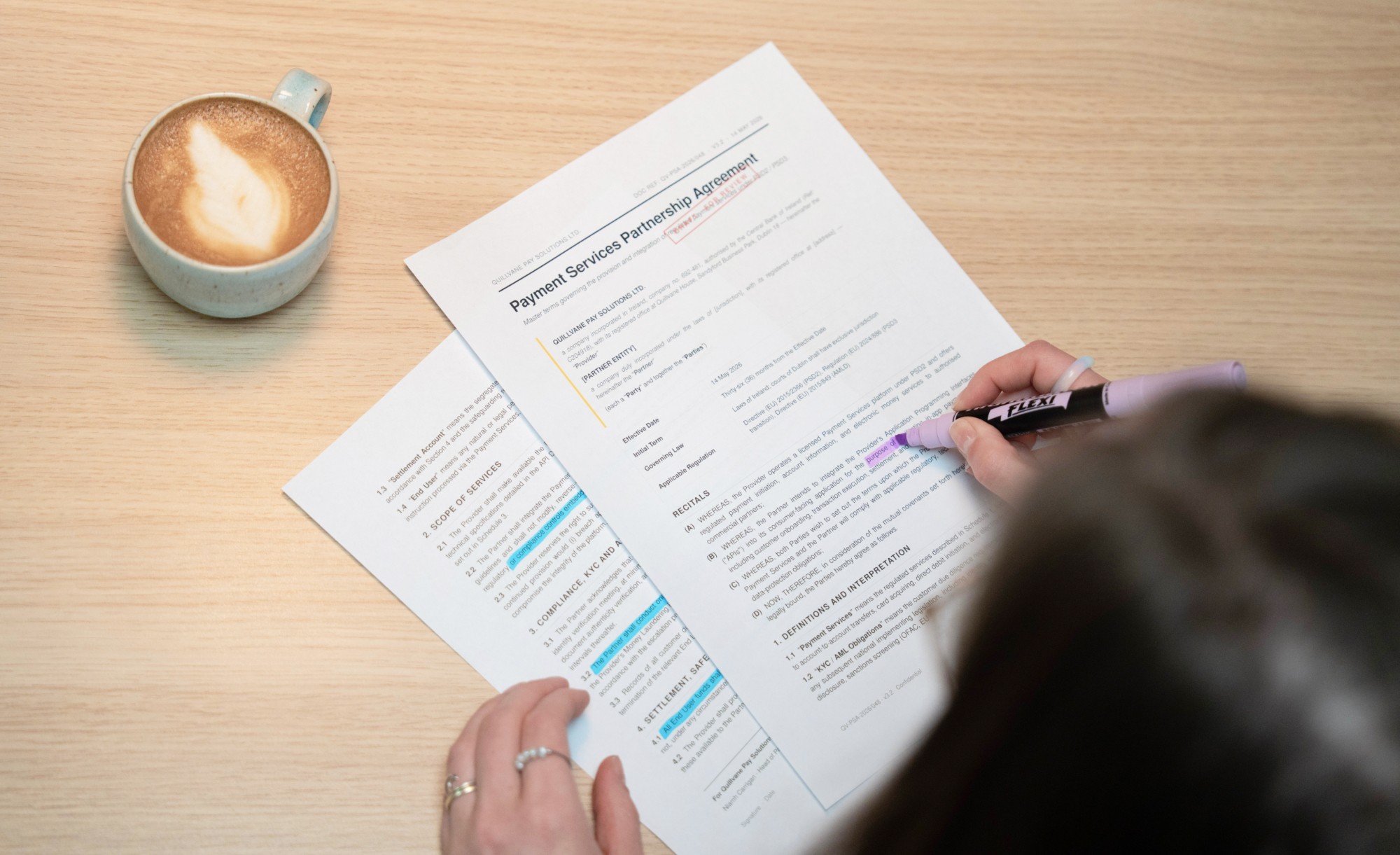 Close-up of a Payment Services Partnership Agreement being reviewed and highlighted, with compliance, KYC/AML, and settlement clauses marked — illustrating the legal roadmap work that runs in parallel with fintech platform development.