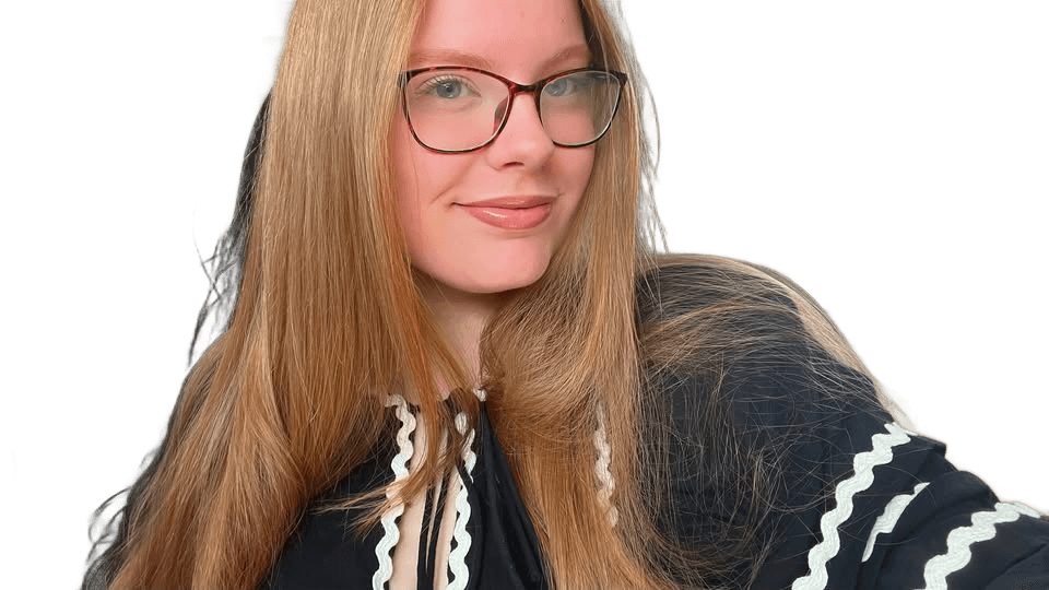 Portrait of Caitlin Jones with blonde hair and glasses