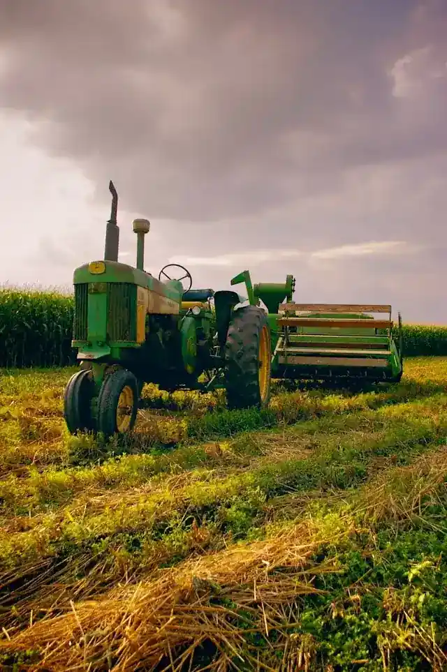 Vintage green John Deere tractor parked in a field