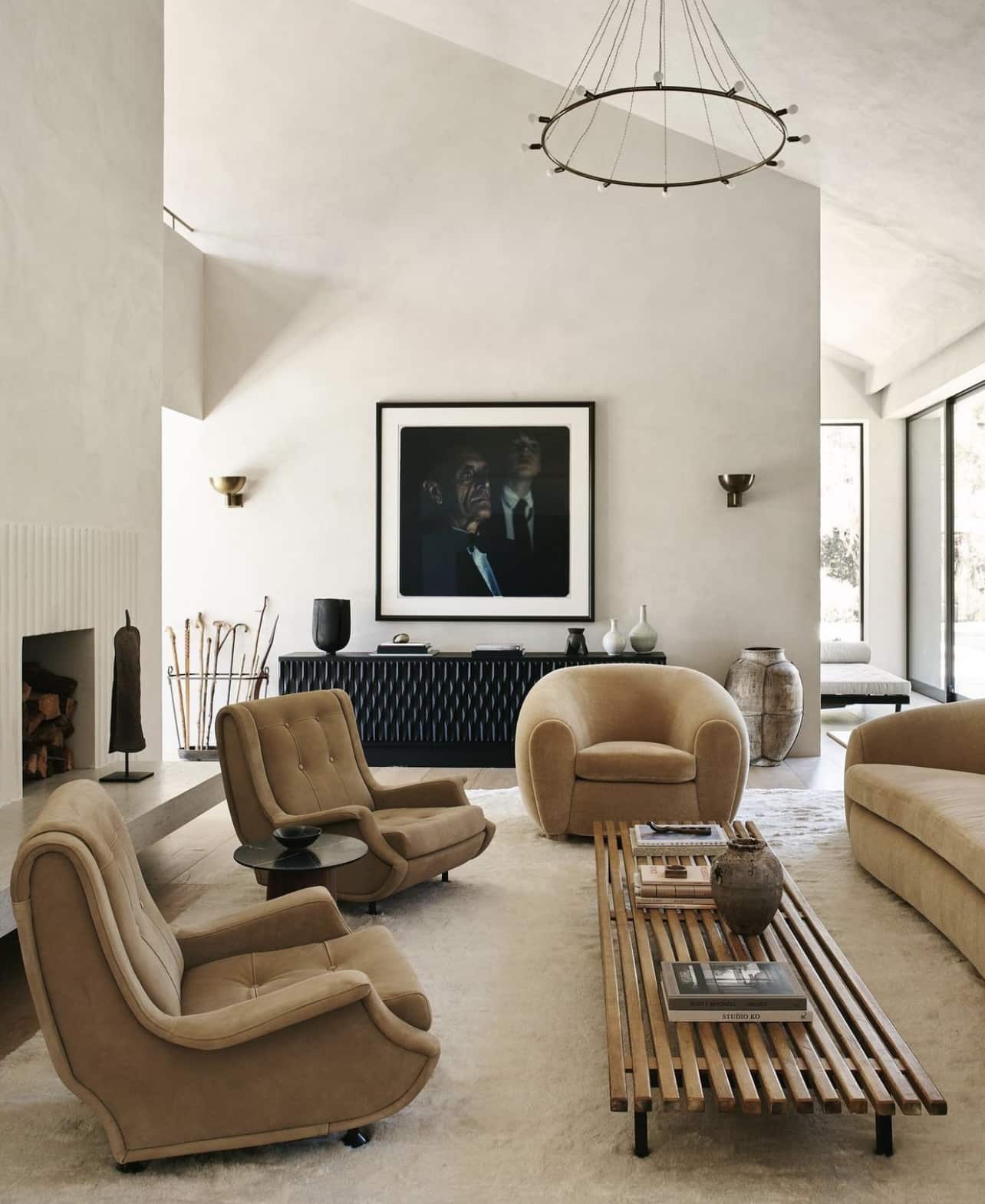 Modern neutral living room with comfy chairs and venetian finish