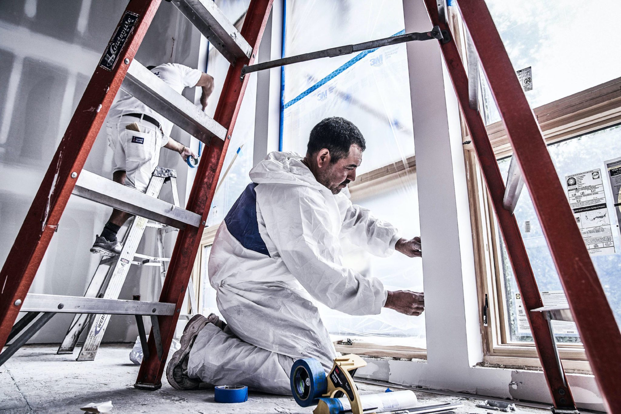 Pro tapes windows during home remodel