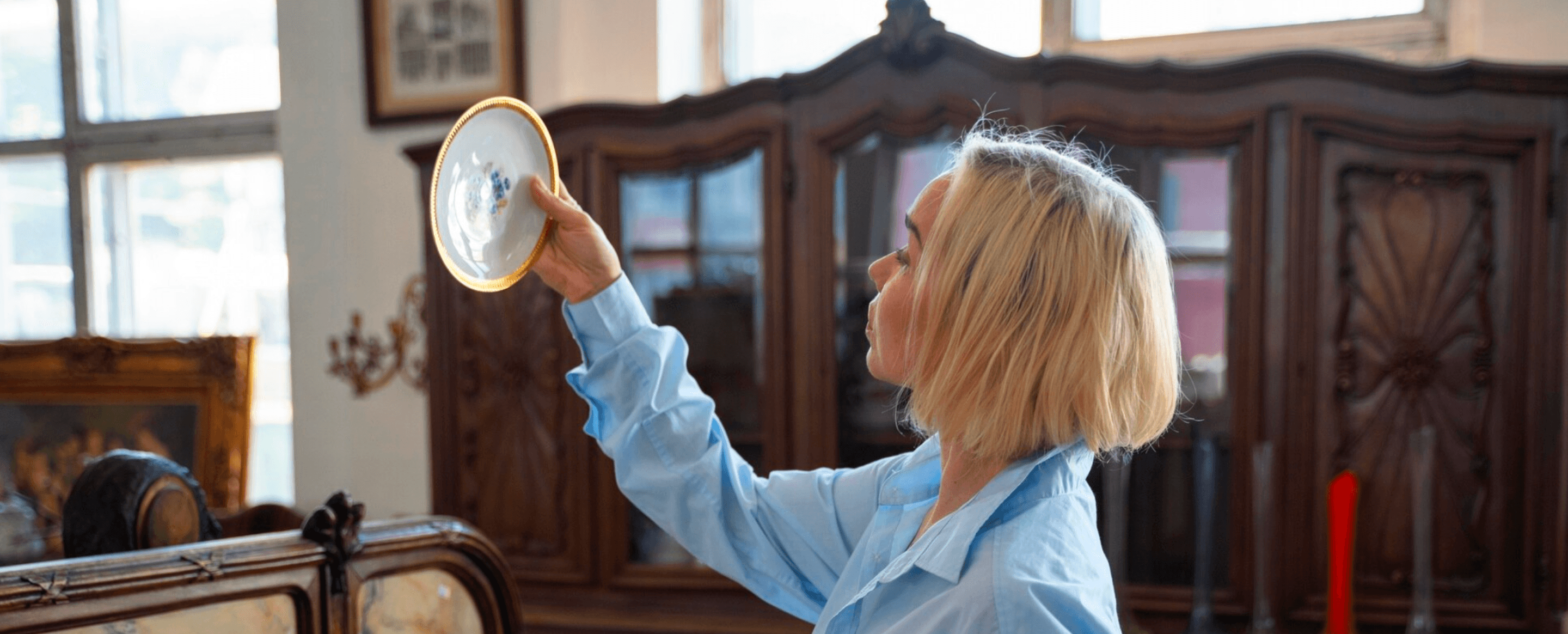 Dealer woman looking at antique item
