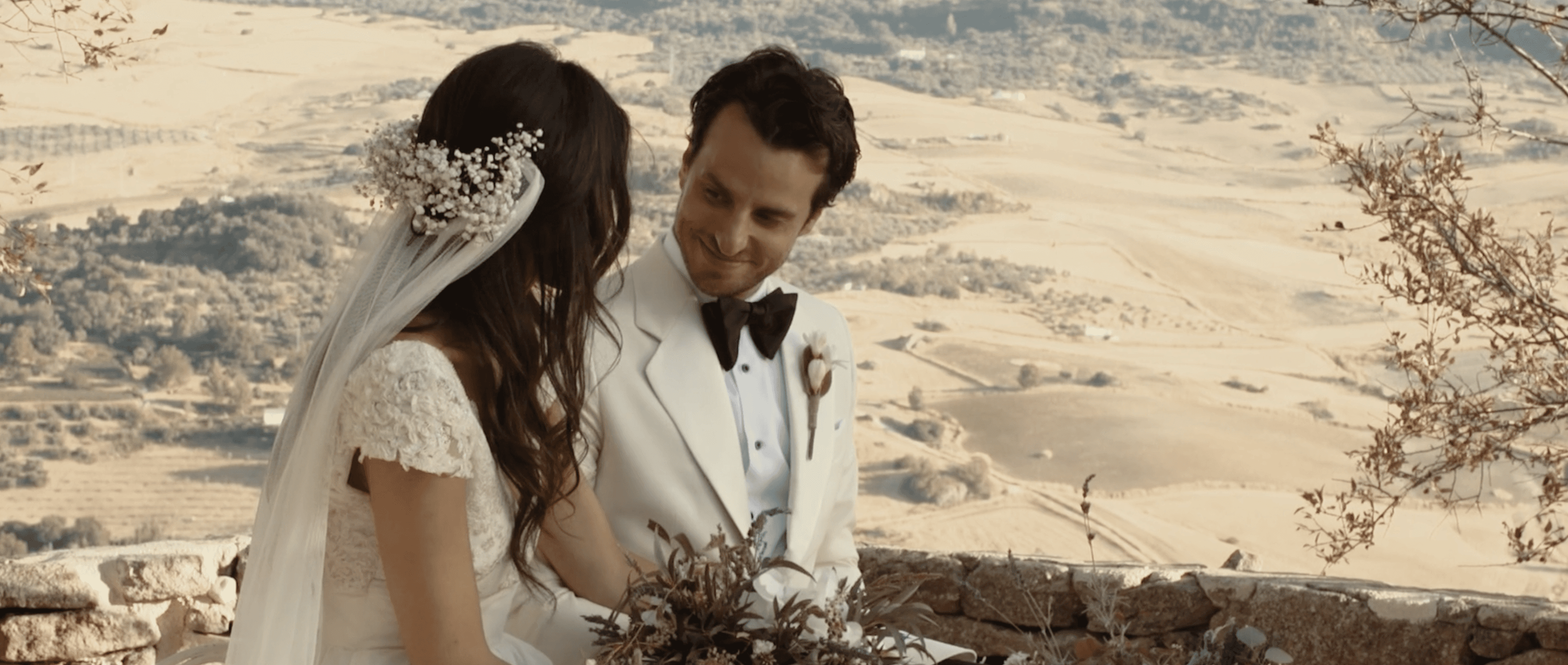 “Bride and groom sharing a moment with the Spanish countryside in the background. Elegant destination wedding photography in Ronda, Spain.”