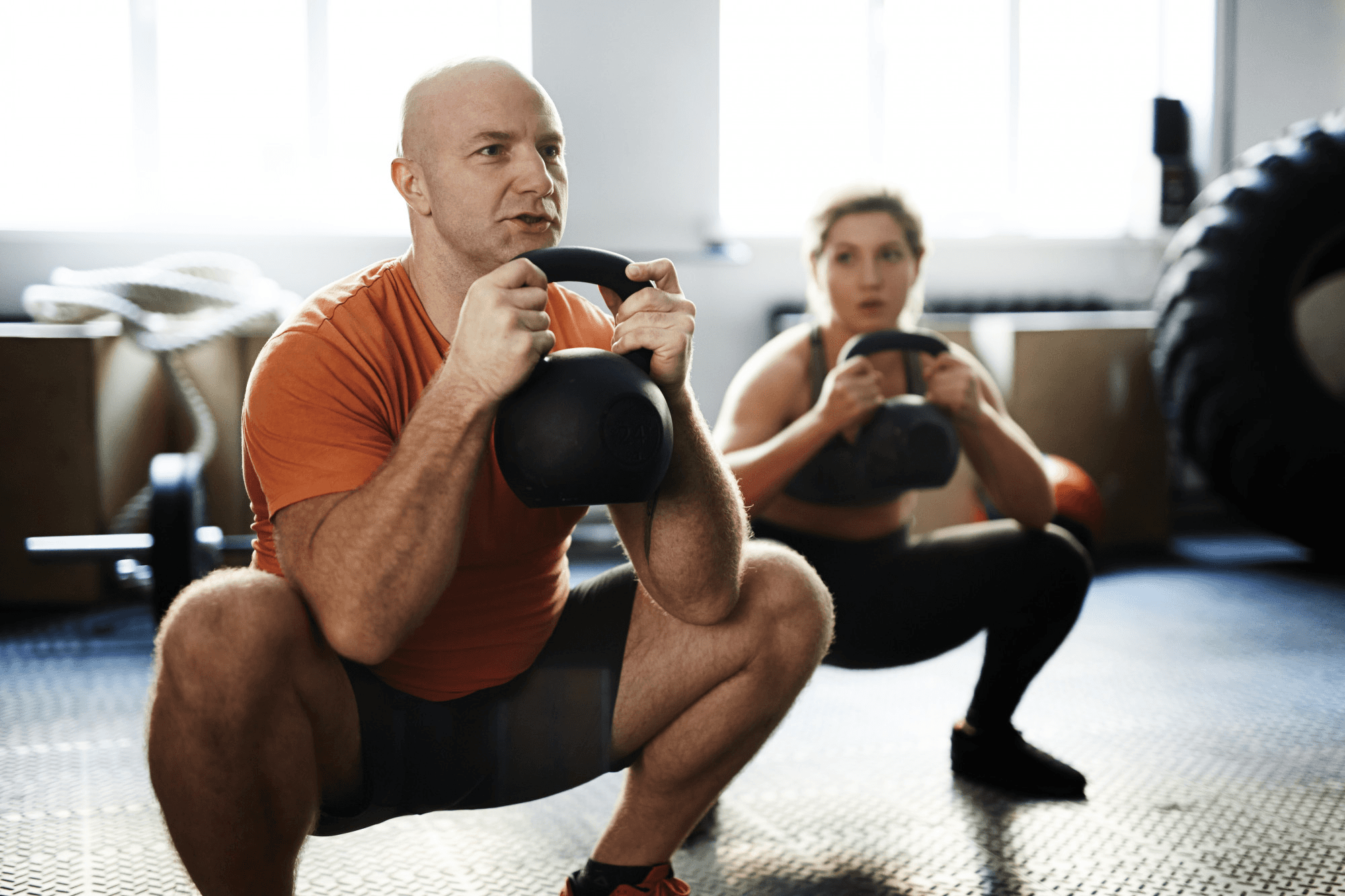 Squats with kettle bells with a personal trainer.