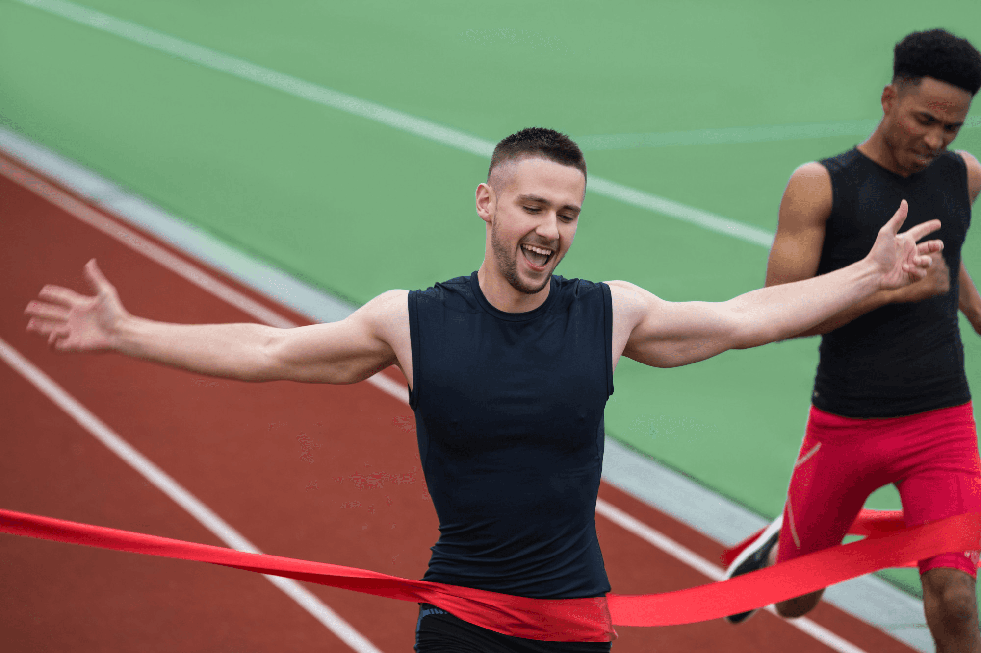 Young athlete crossing the finish line of a marathon.