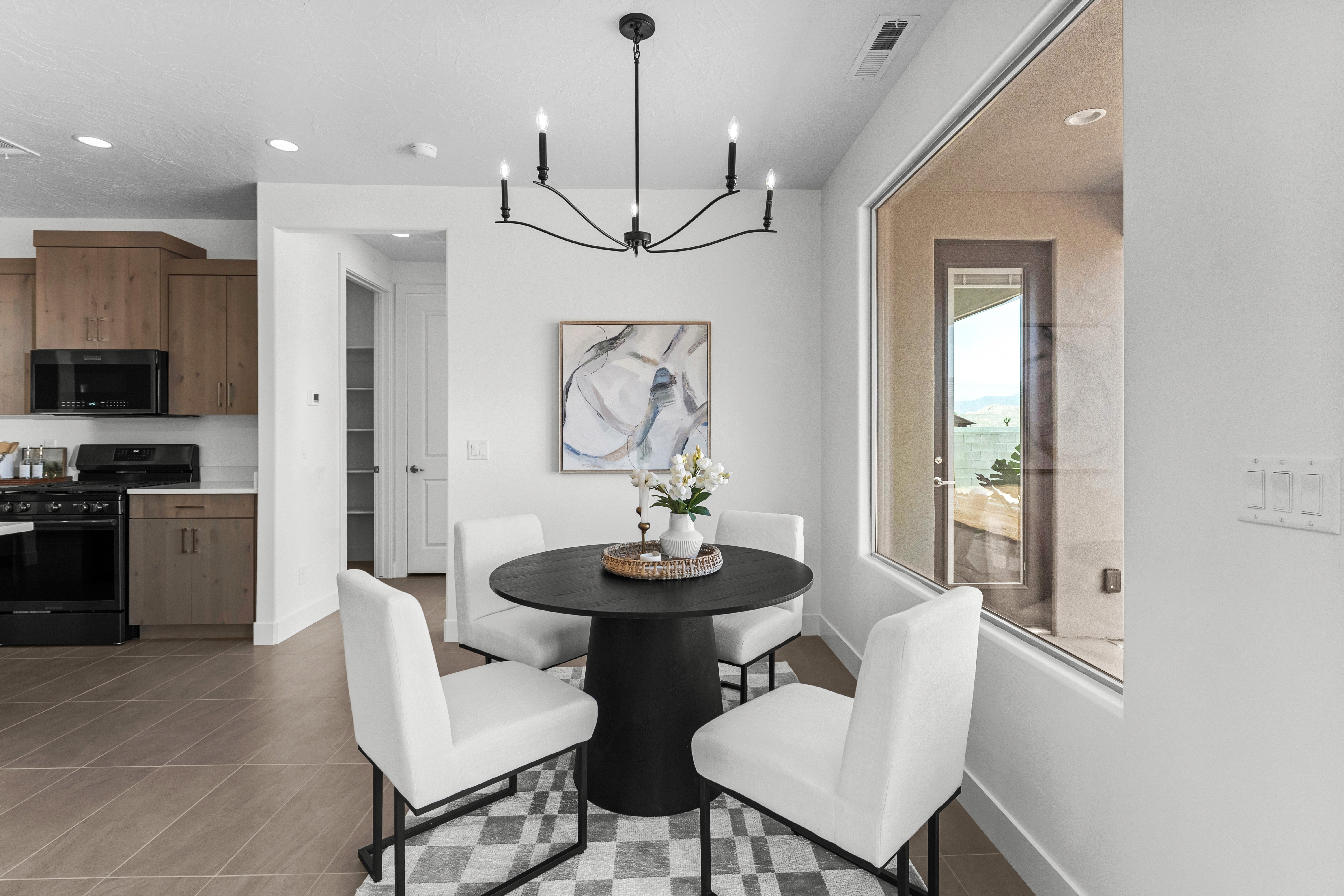 Dining room of The Nest at Falcon Ridge in Hurricane, Utah, featuring ample natural light and an open concept layout.