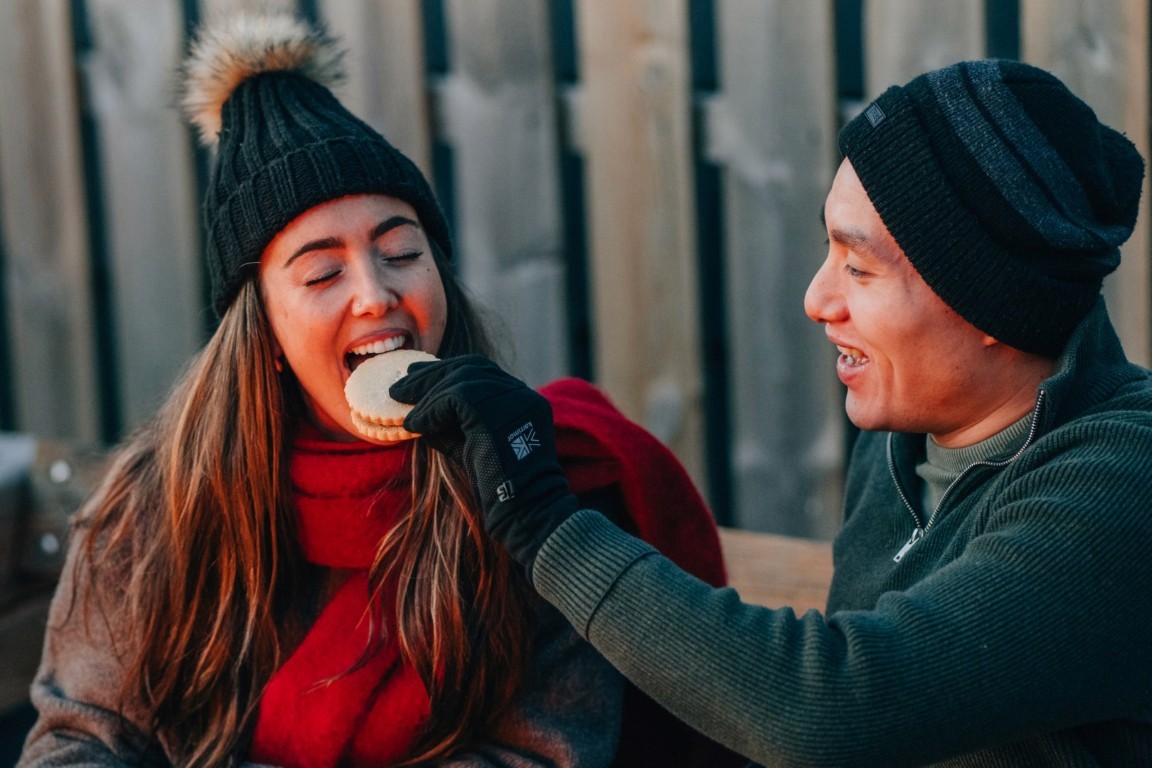 A couple enjoying Shortbread by the fire. 