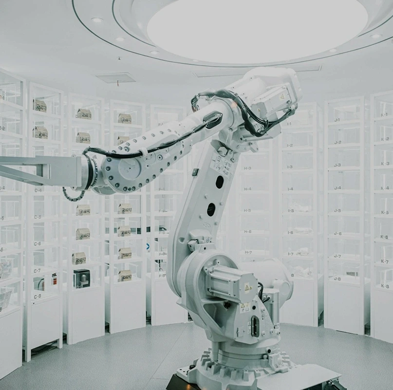 Industrial robotic arm in a sterile white medical device manufacturing facility