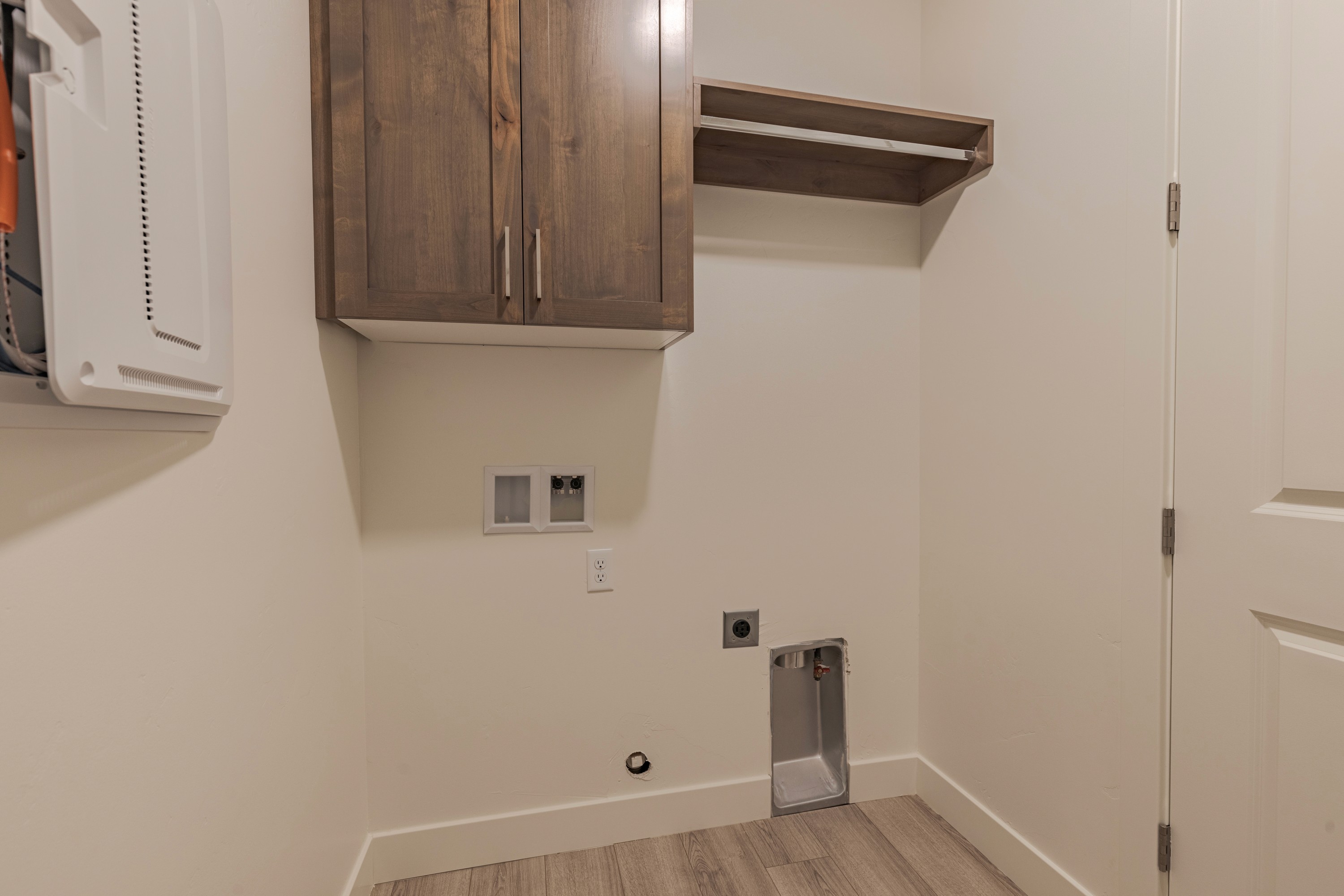 Laundry room in the Painted Sands twin home in Hurricane, Utah featuring cabinetry and functional space for washer and dryer.