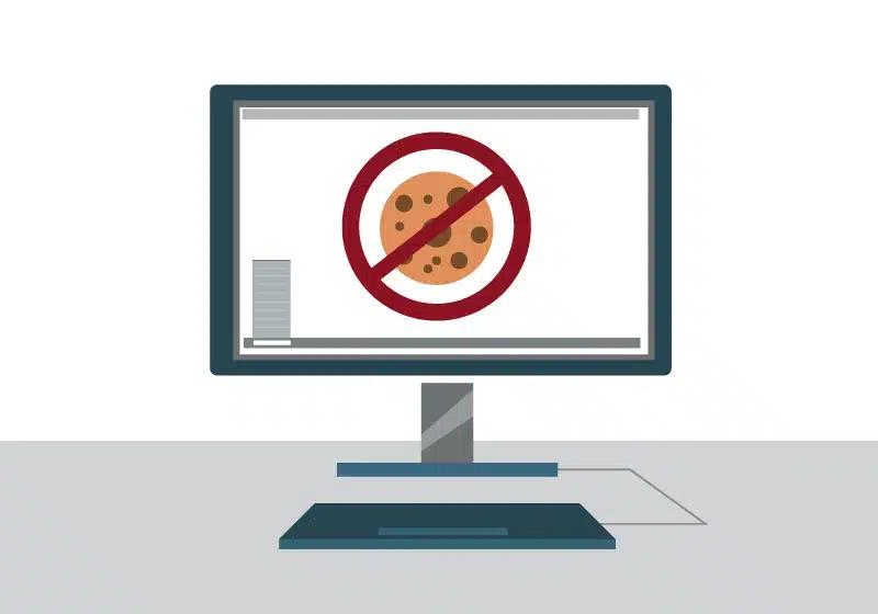A stylized vector of a desktop monitor with a no cookie icon on the screen