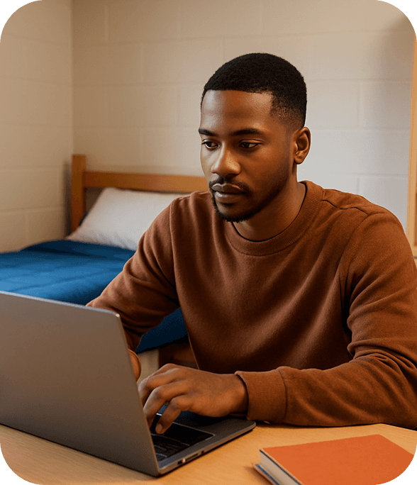 Student with brown shirt studying in his dorm