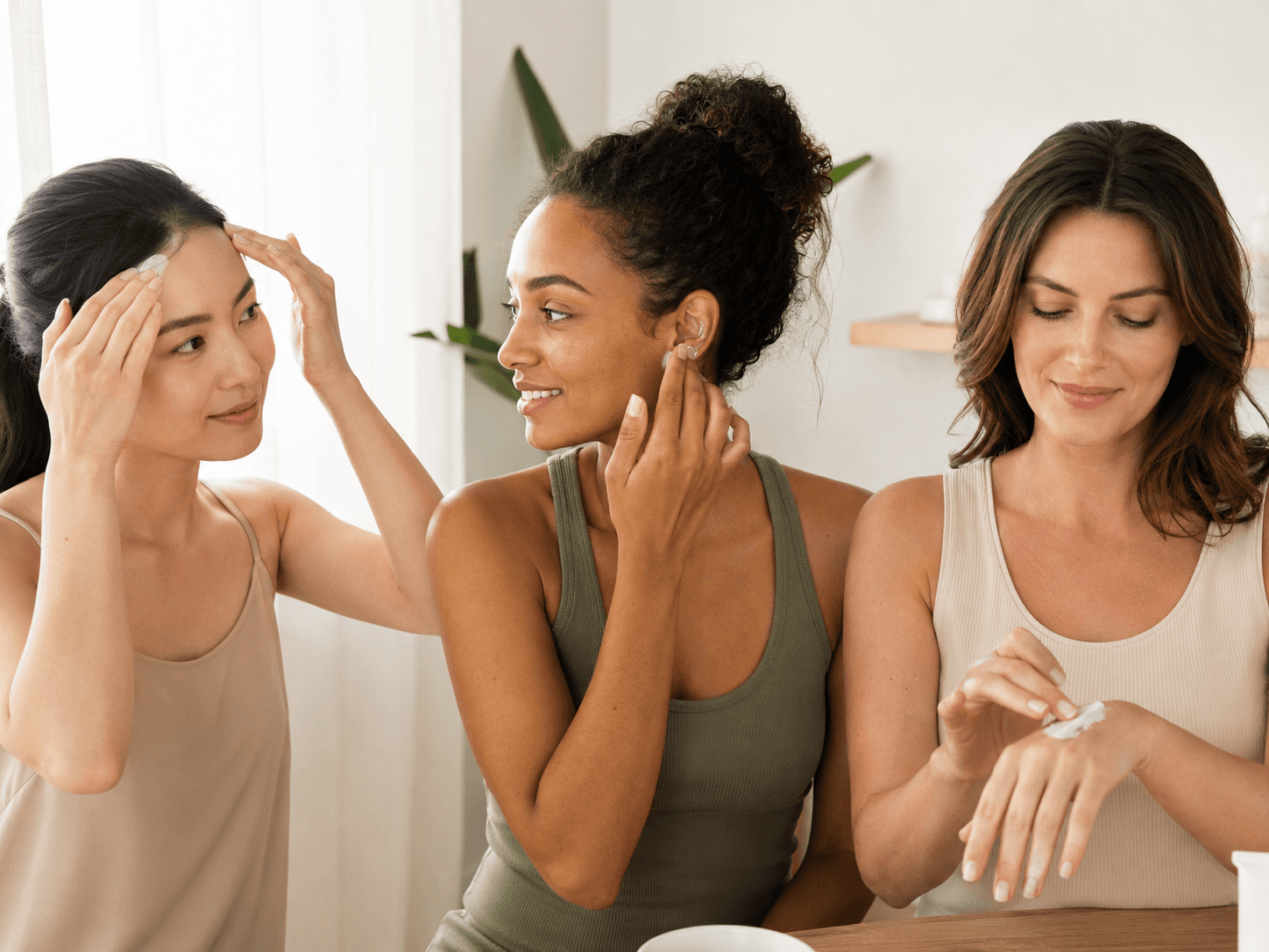 Women applying sunscreen to the hairline, ears, and hands as part of a dermatologist-recommended sun protection routine.