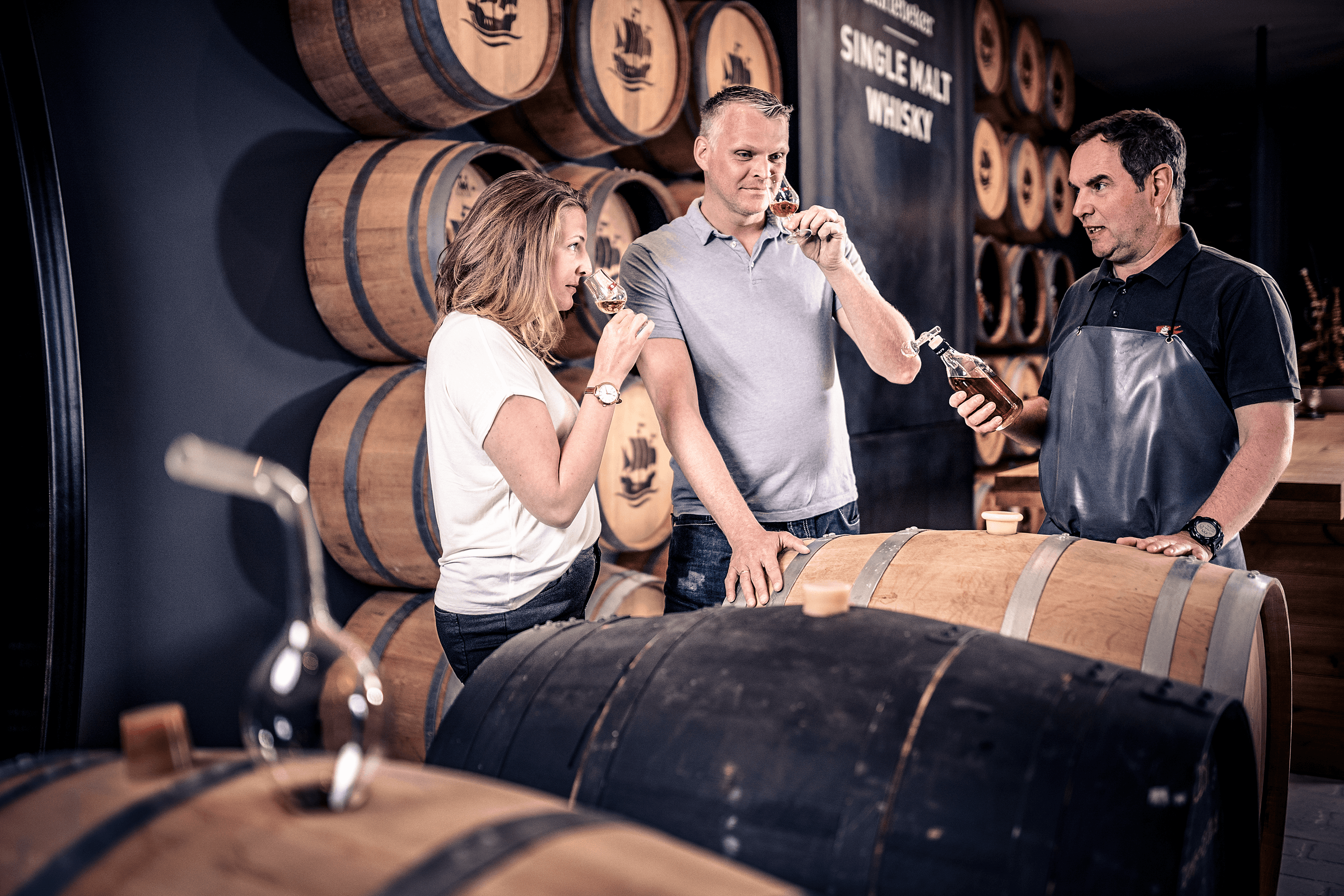 Whisky tasting with barrels in background