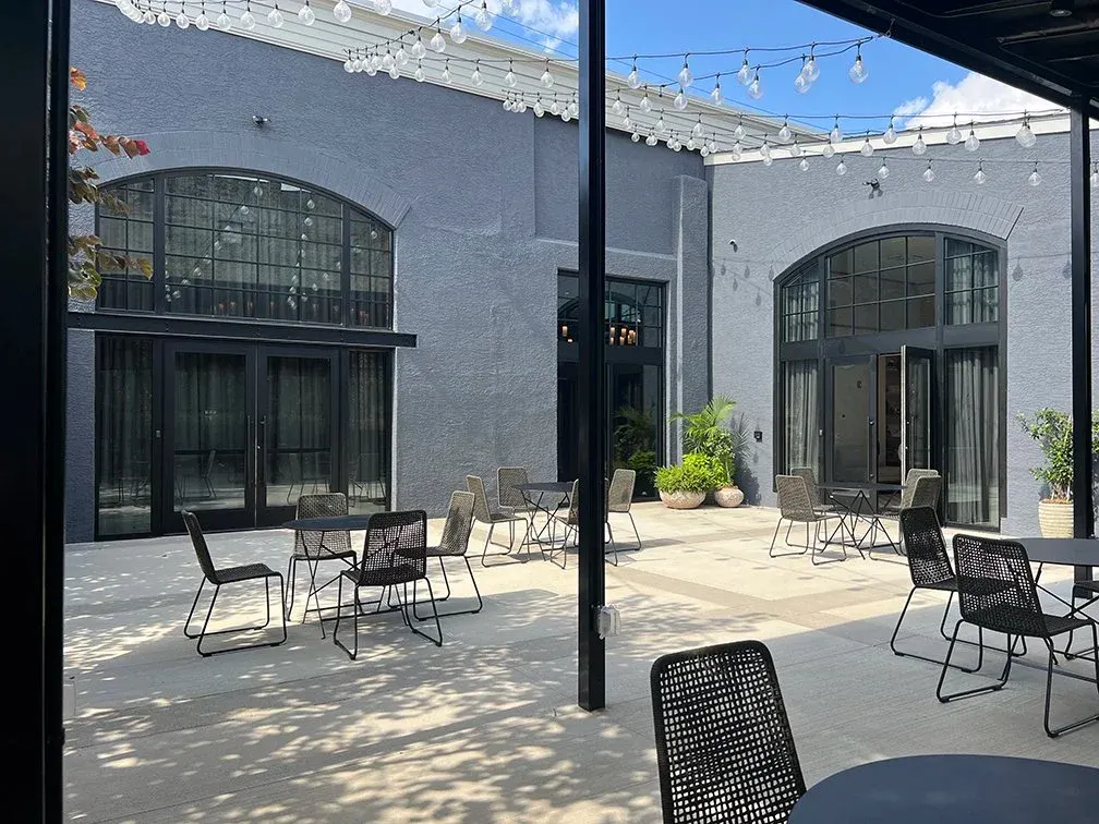 Gated outdoor Veranda with string lights and patio chairs