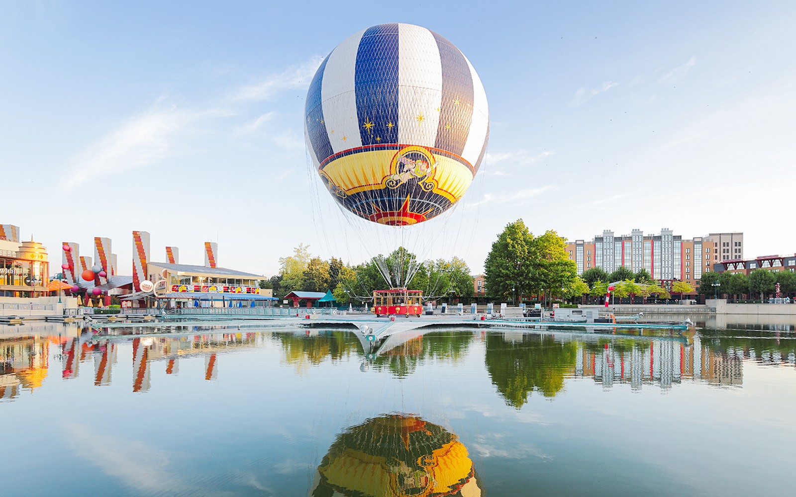 Ballon Panoramagique floating over a reflective lake at Disneyland Paris.