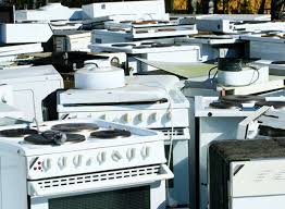 A bunch of microwaves that are on a shelf