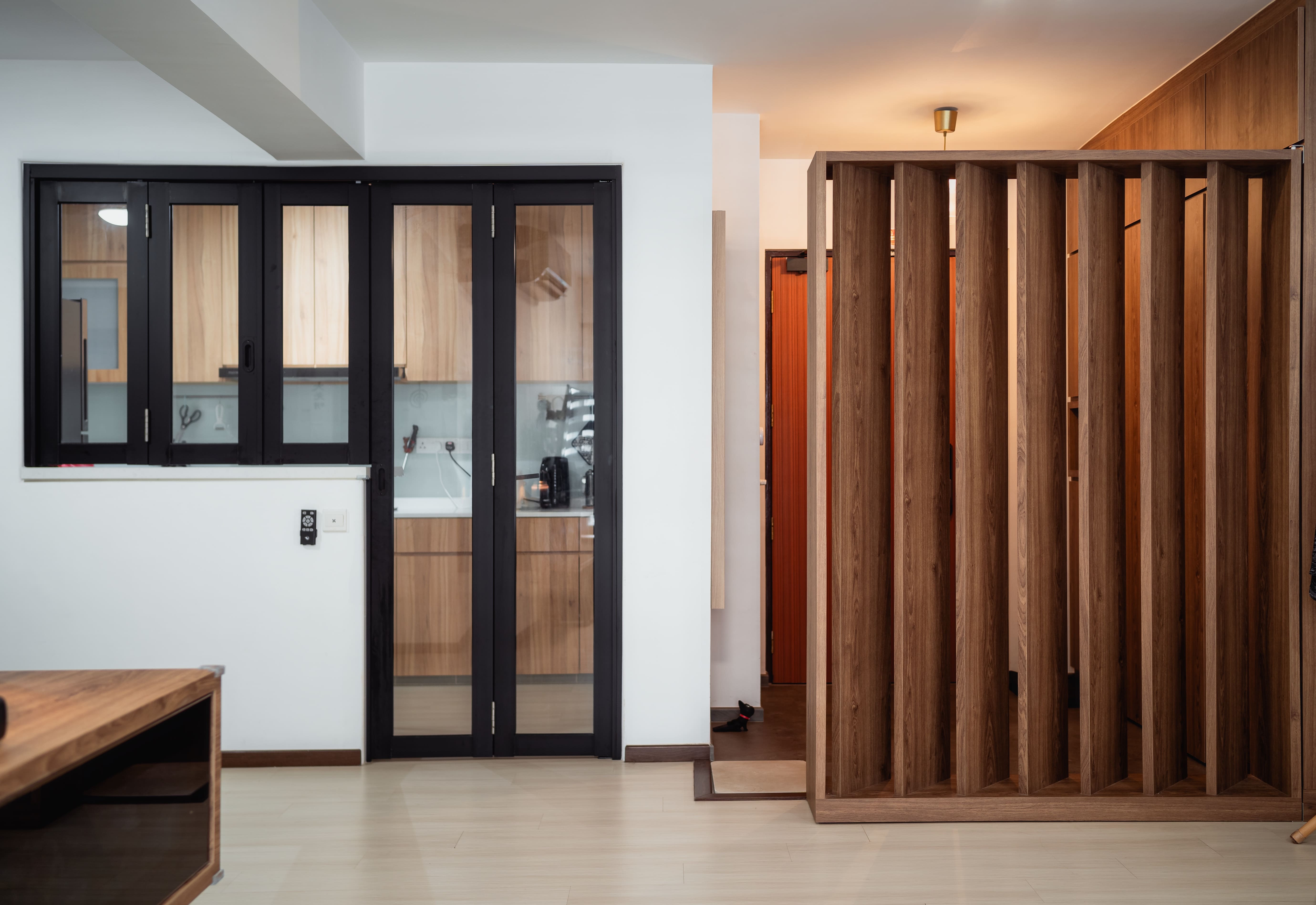 Entryway defined by vertical wood slats, offering privacy while keeping the foyer visually open.