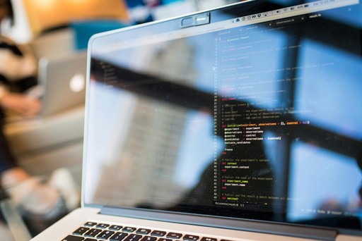A laptop screen with visible code.