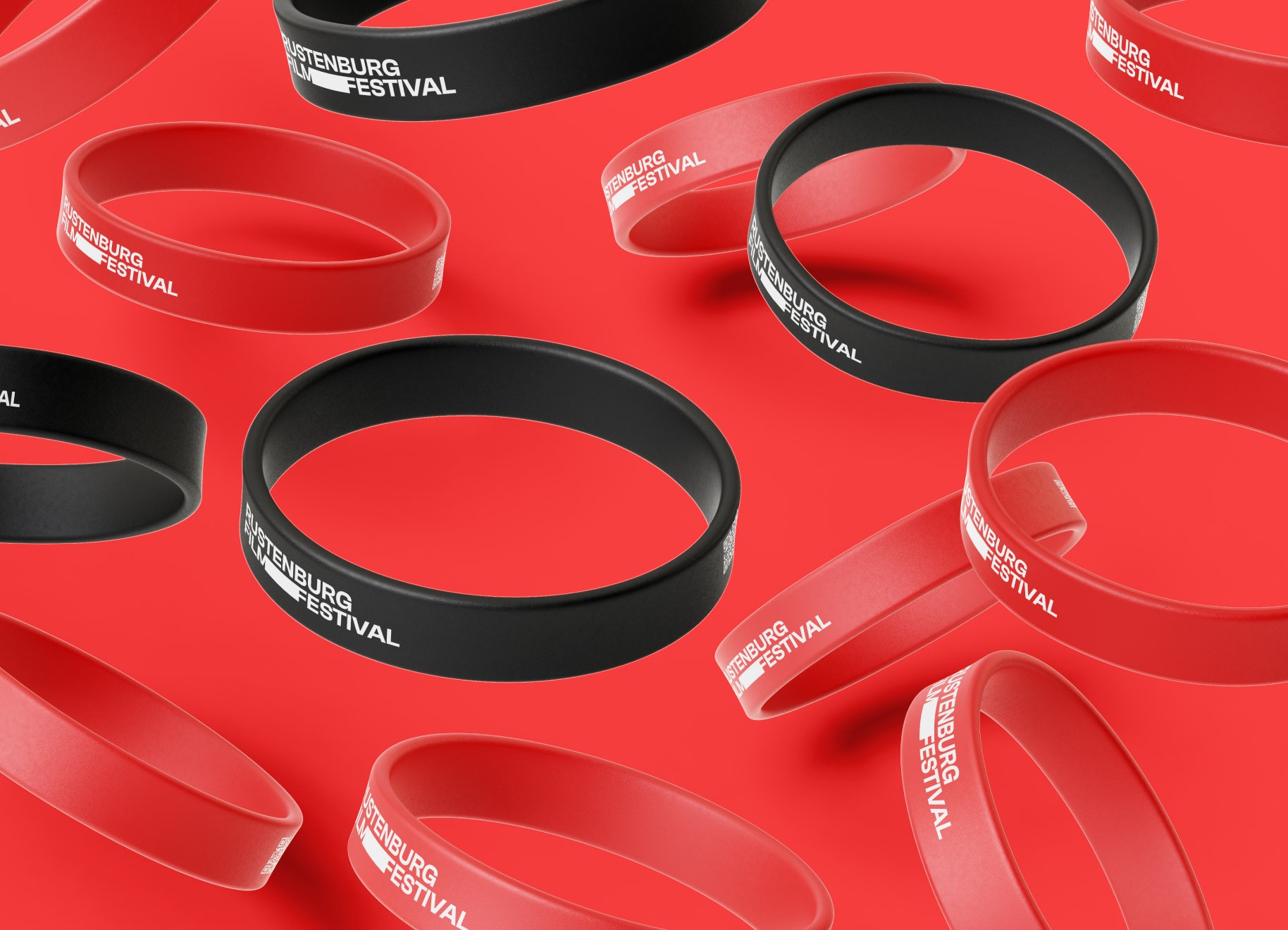 A bunch of RFF wrist bands, suspended in the air, with a bright red background