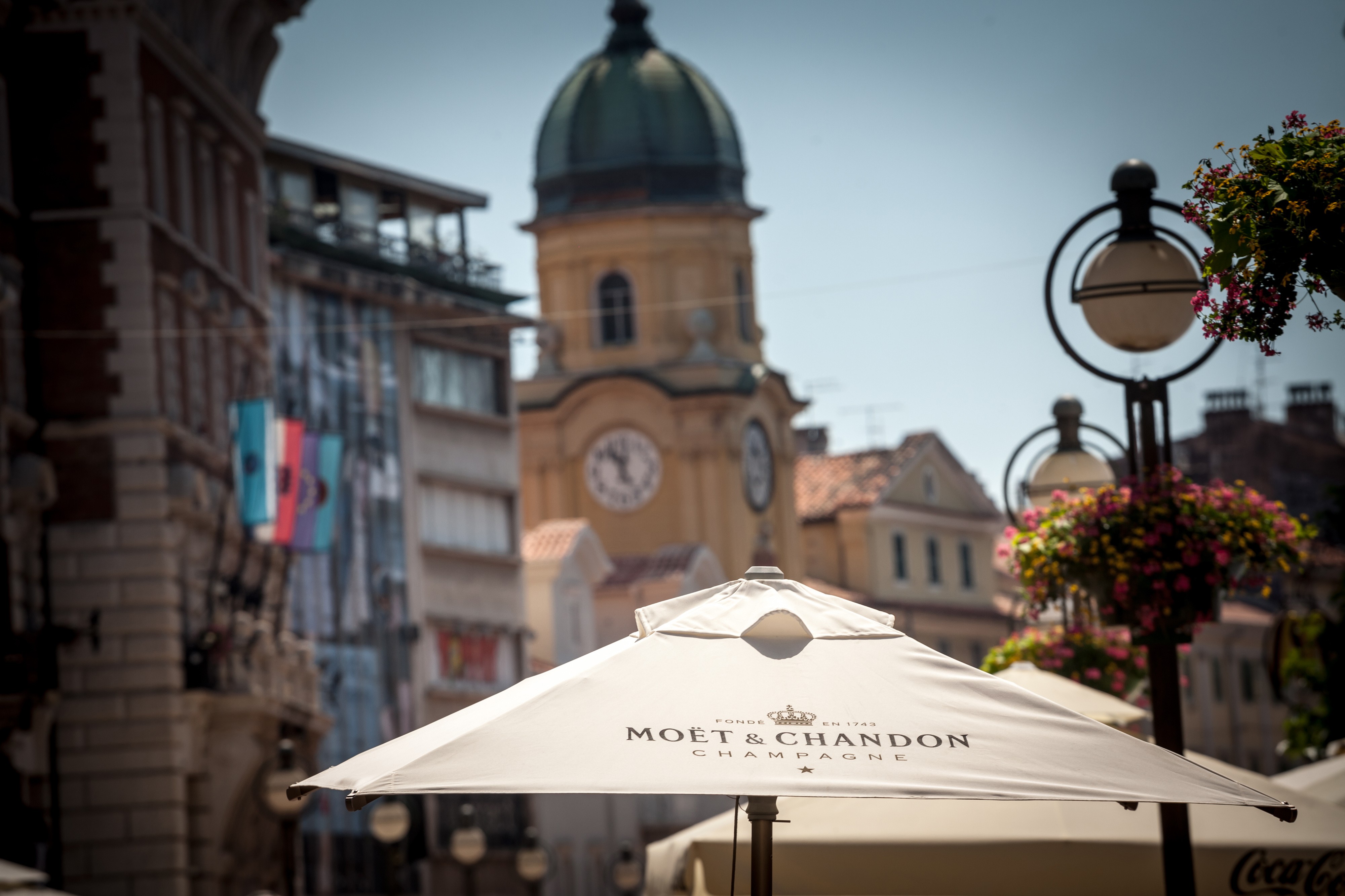 White parasol in a city that says Moët Chandon