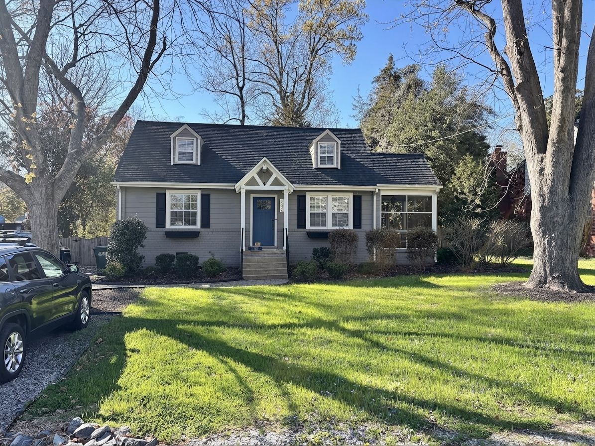 Cape Cod brick house with deep navy blue front door