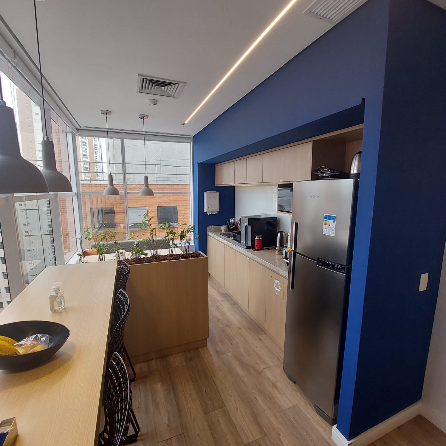 Contemporary interior with sculpted angled walls and a skylight filling the space with natural light.