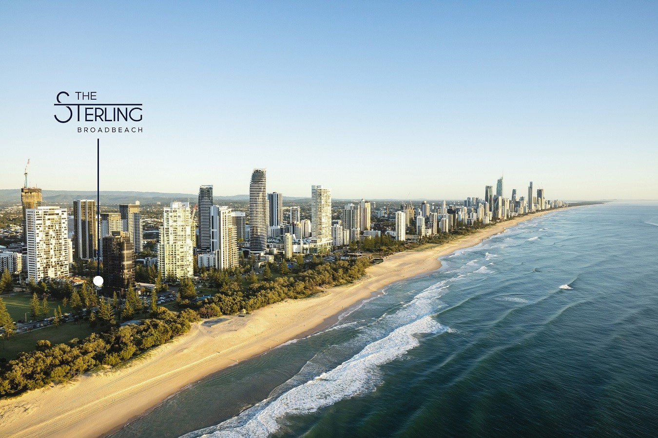 Aerial view of Broadbeach coastline showing The Sterling’s beachfront location surrounded by luxury towers, green parklands and the Pacific Ocean stretching along the Gold Coast.