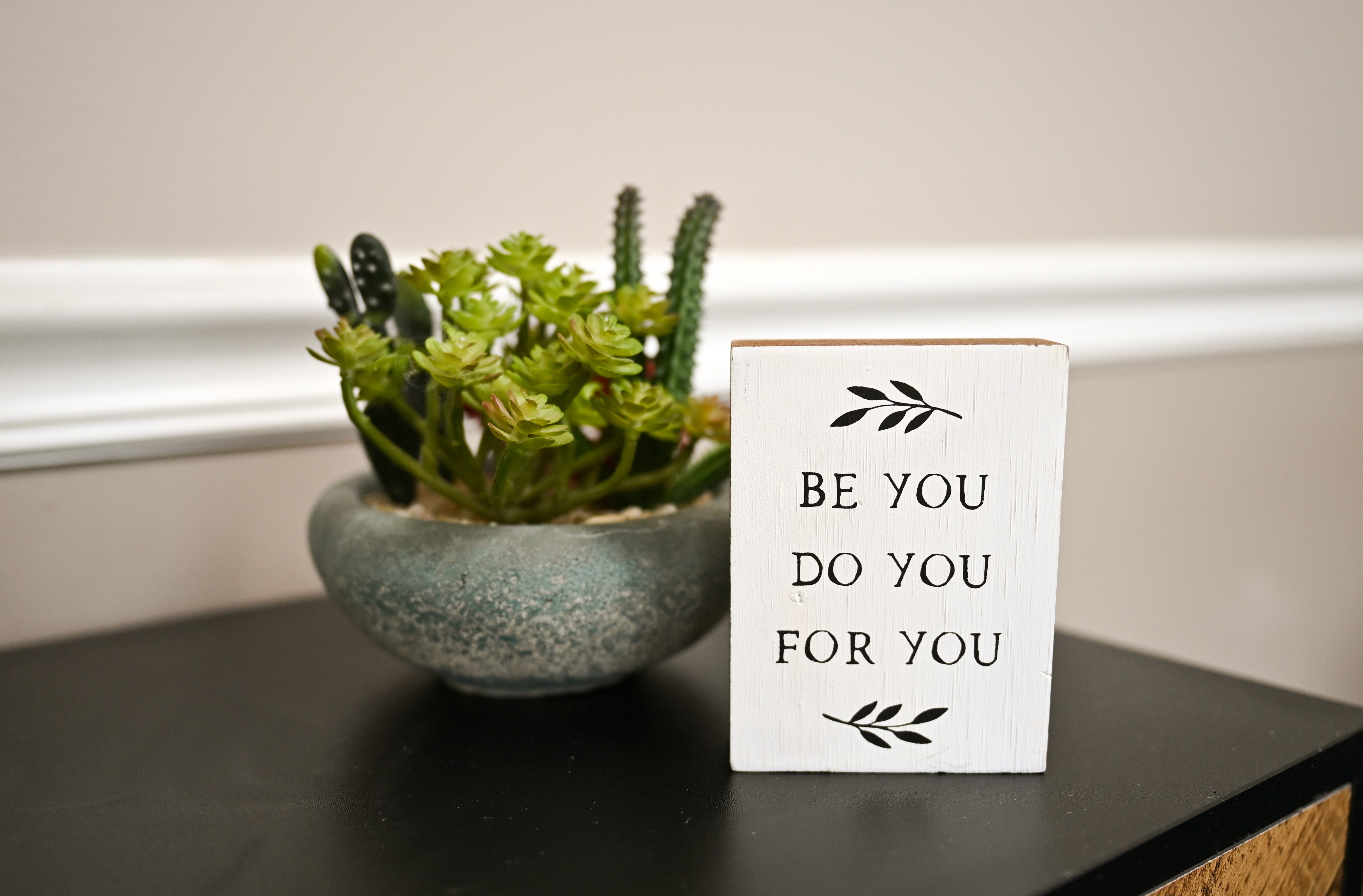 A woman holding a "namaste" pose as if she's meditating.