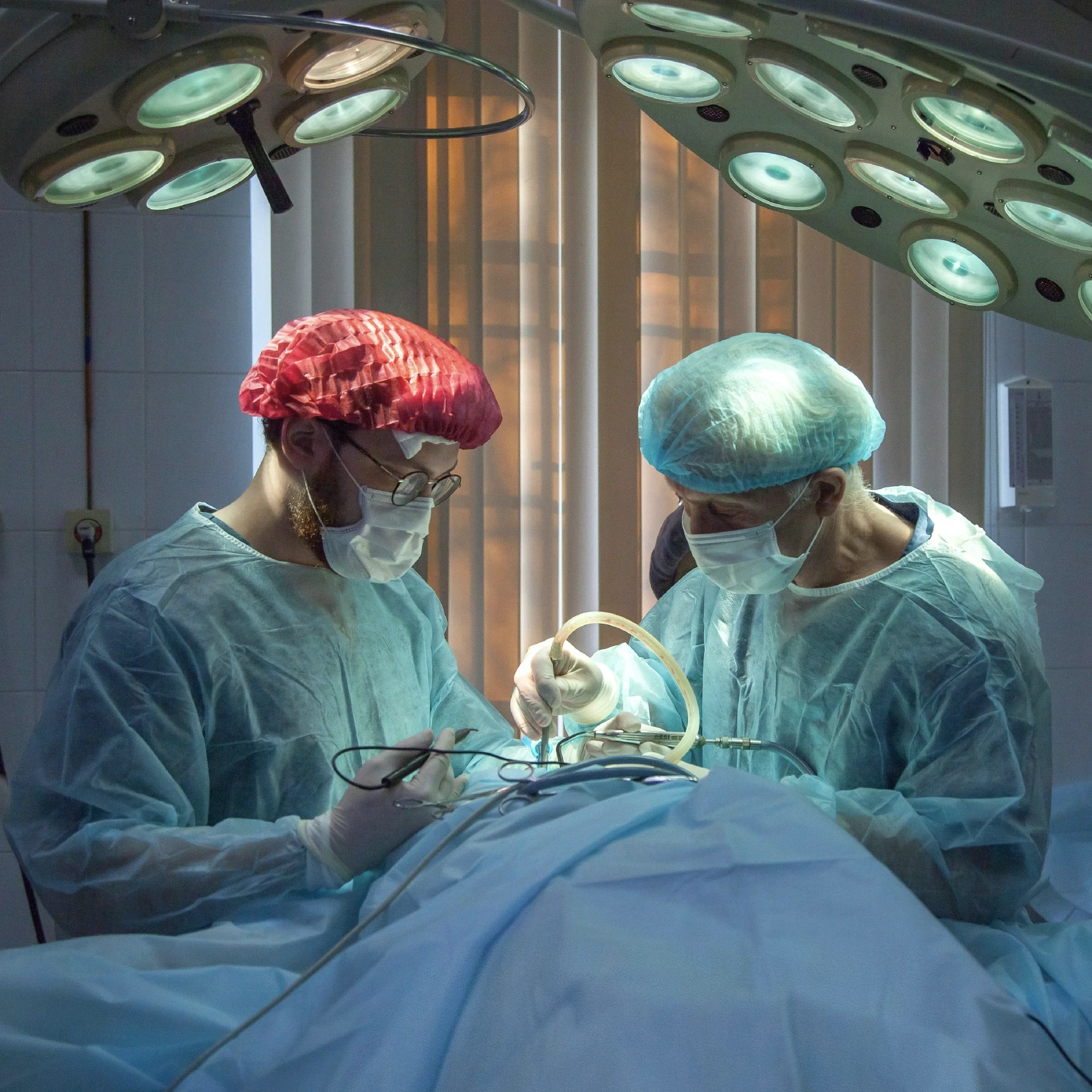 A surgery room with two doctors operating on a body