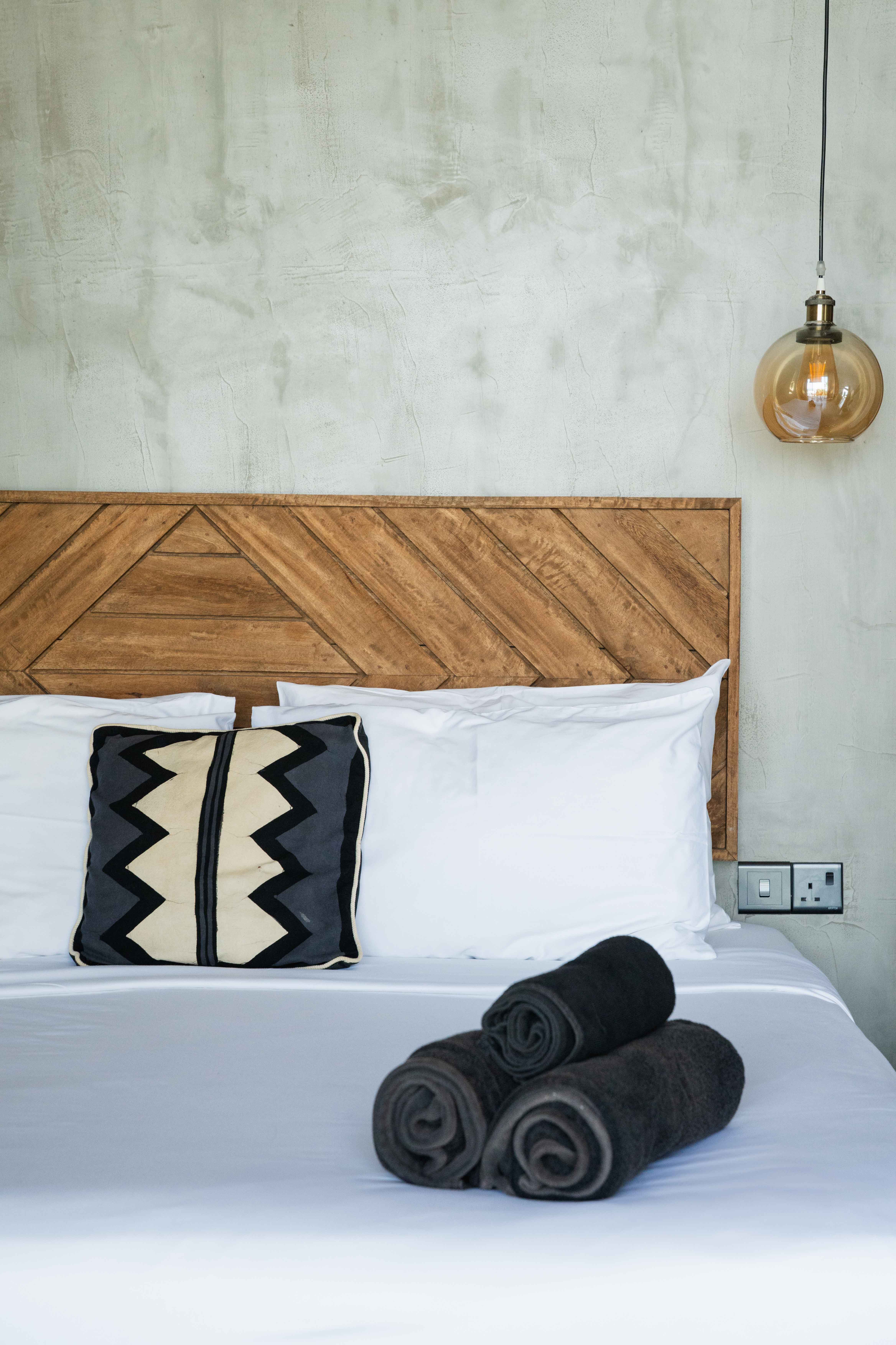 Close up of hotel bed with towels in top