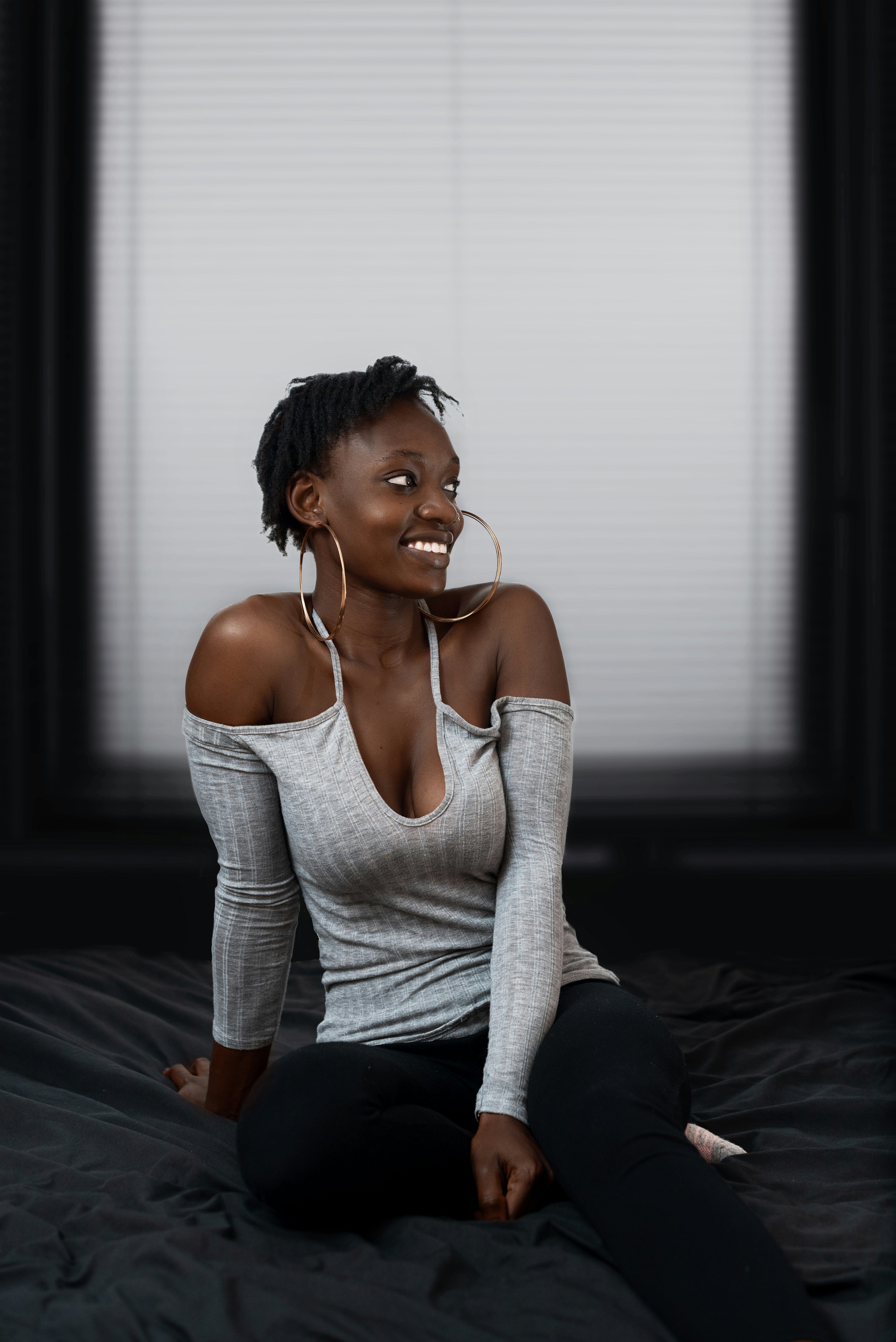 A woman on the ground smiling for a profile picture