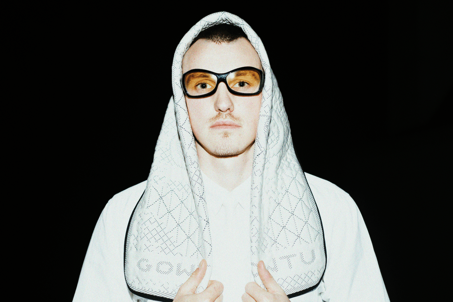 Image of a bed with a cup of coffee sitting on it