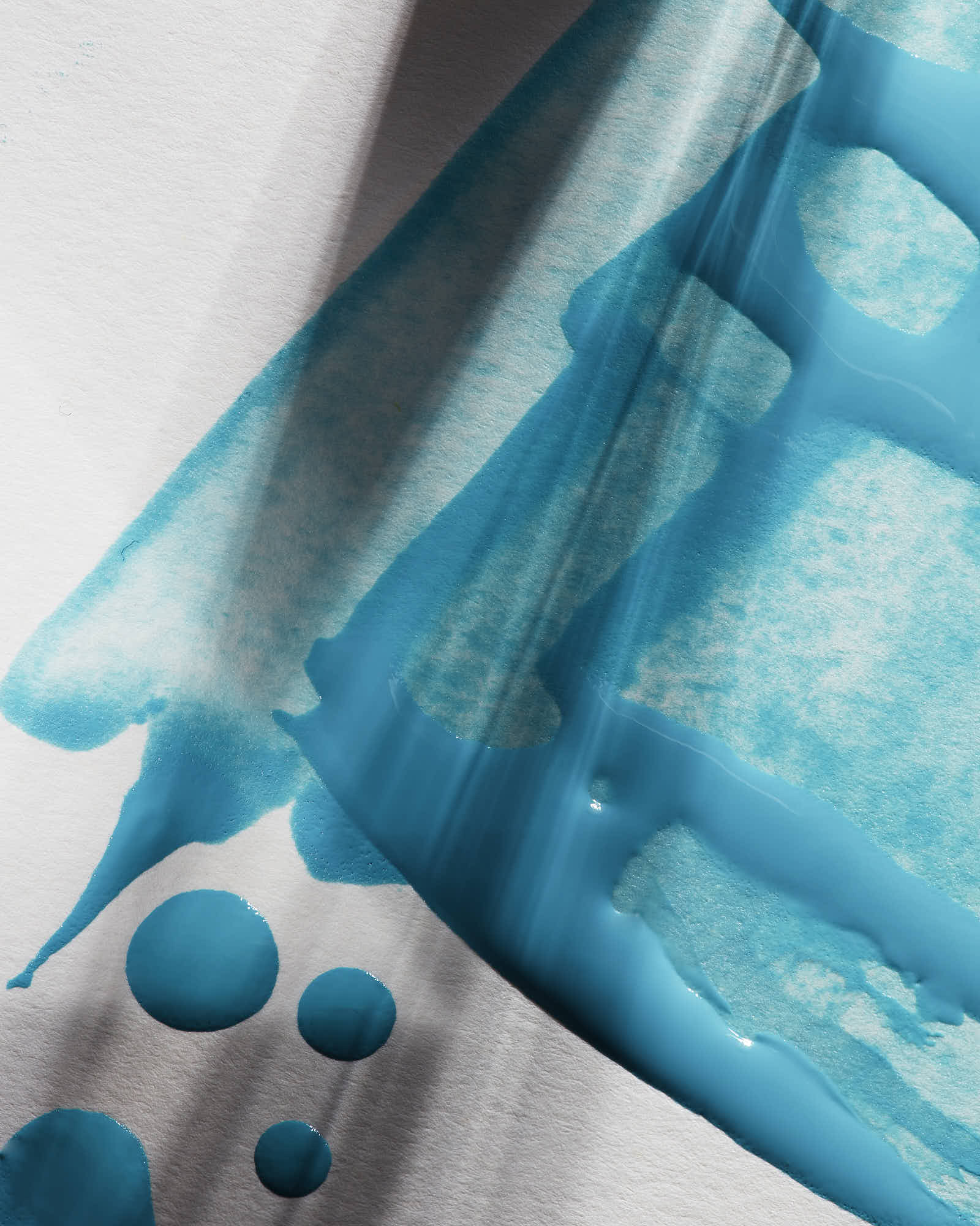 Close-up of a blue liquid on , highlighting the fluid's texture and bubbles.