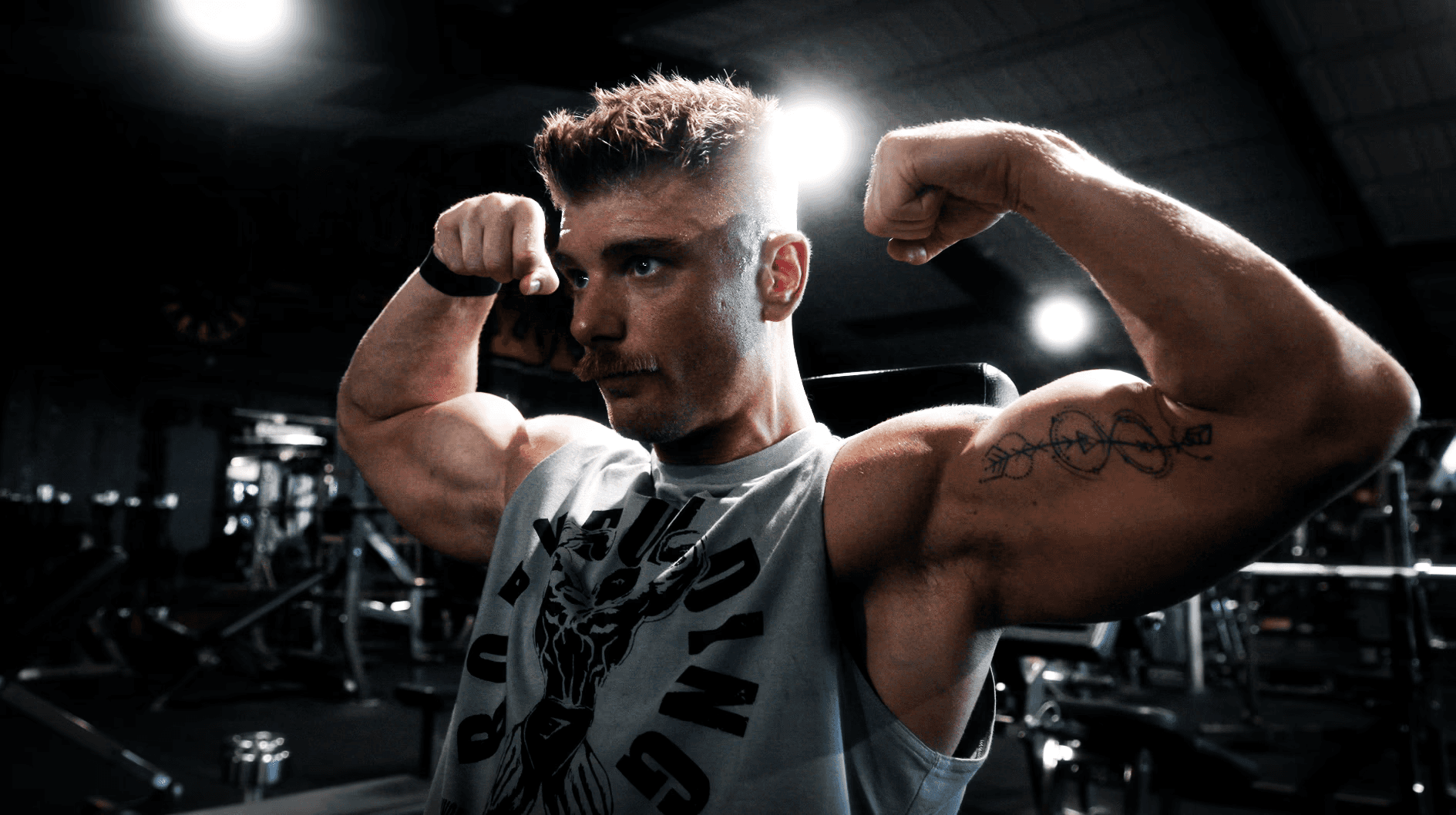 A man sitting on the ground in a gym