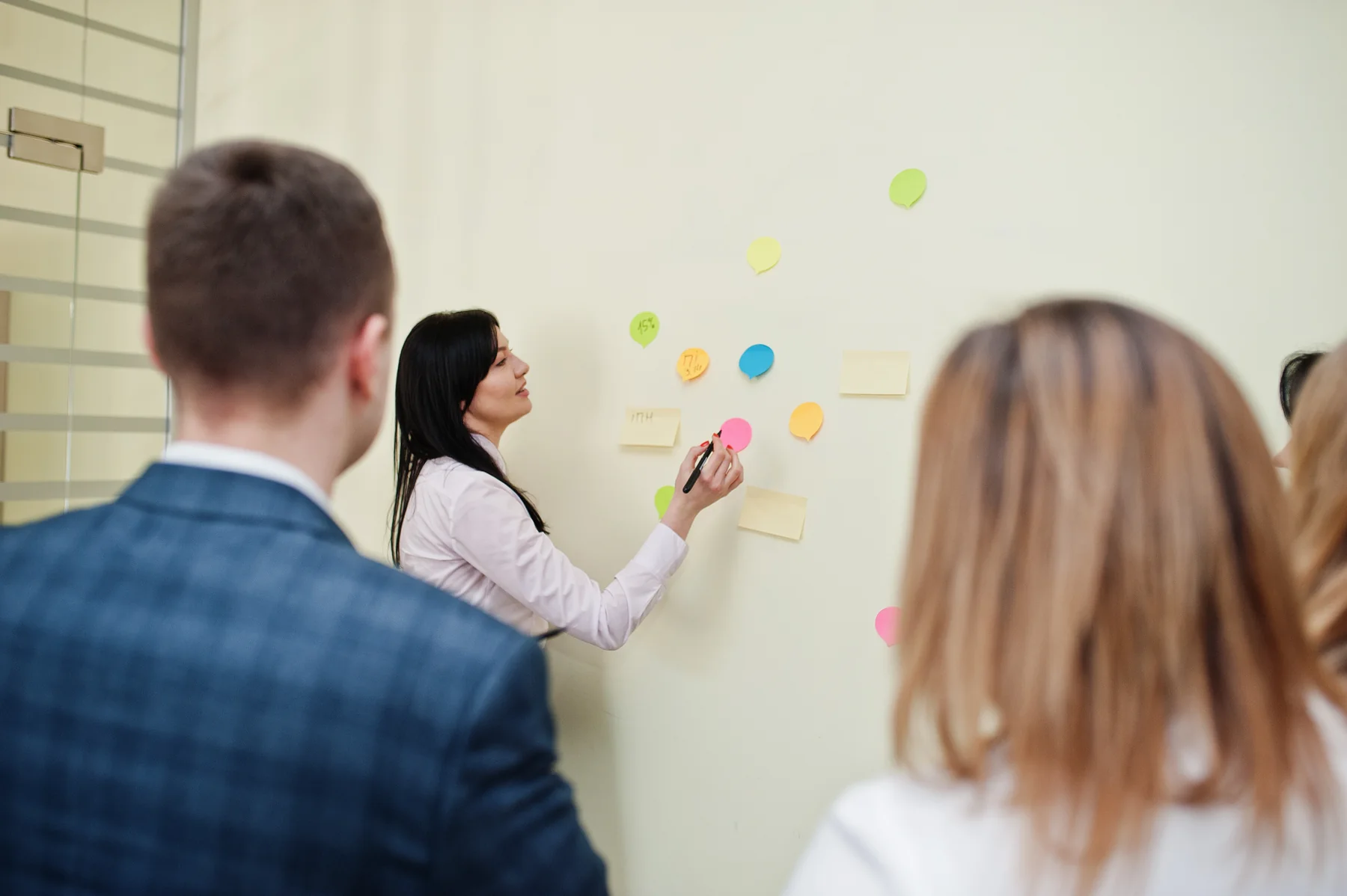 Professional Woman Presenting Ideas to Team in Office