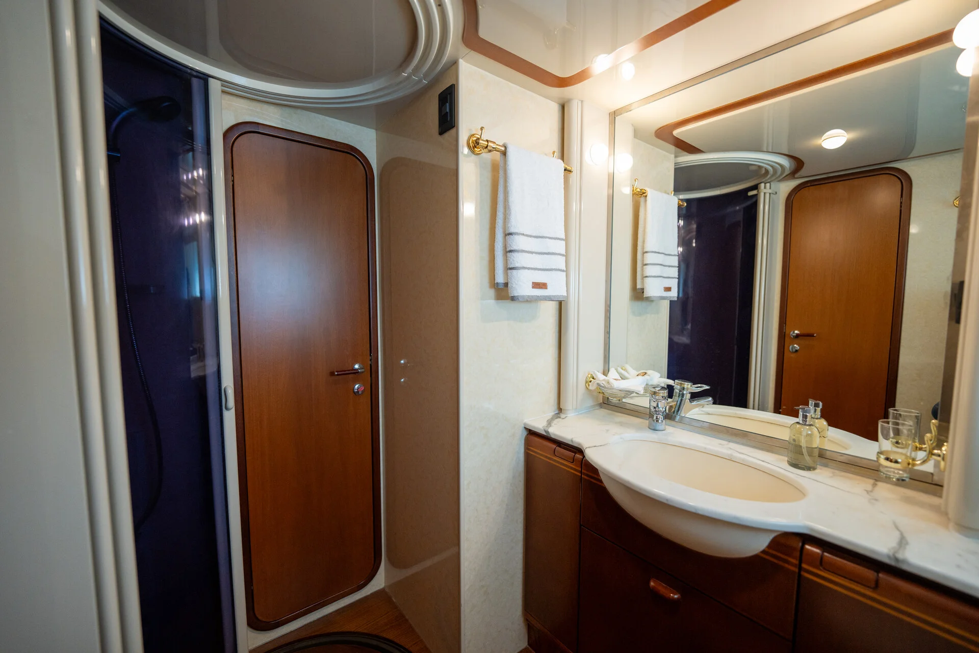 White Rock 36 speedboat with captain at helm cruising calm blue waters near Paros coastline with hills in background.