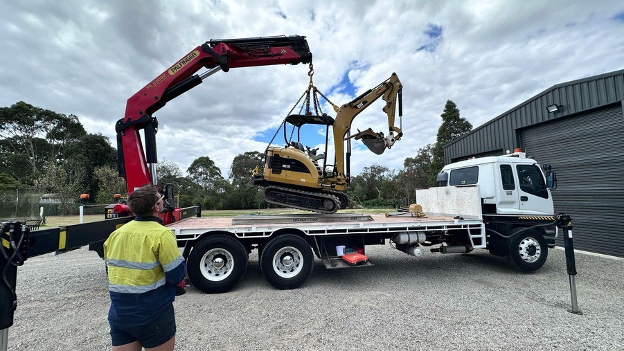 Crane truck being lifted of from truck