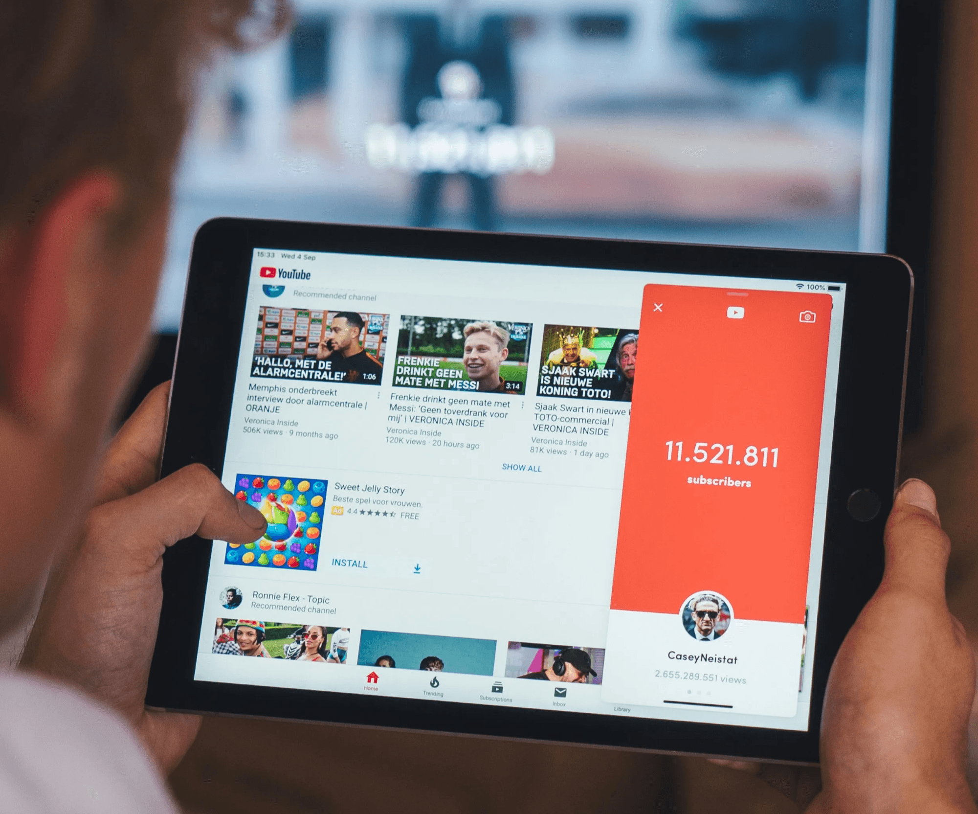 Person browsing YouTube on tablet device - YouTube Hooks