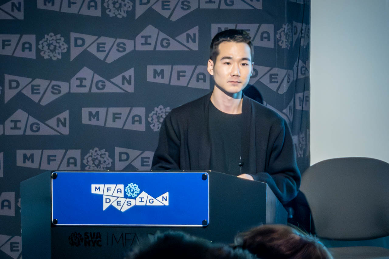 man at a podium delivering a presentation