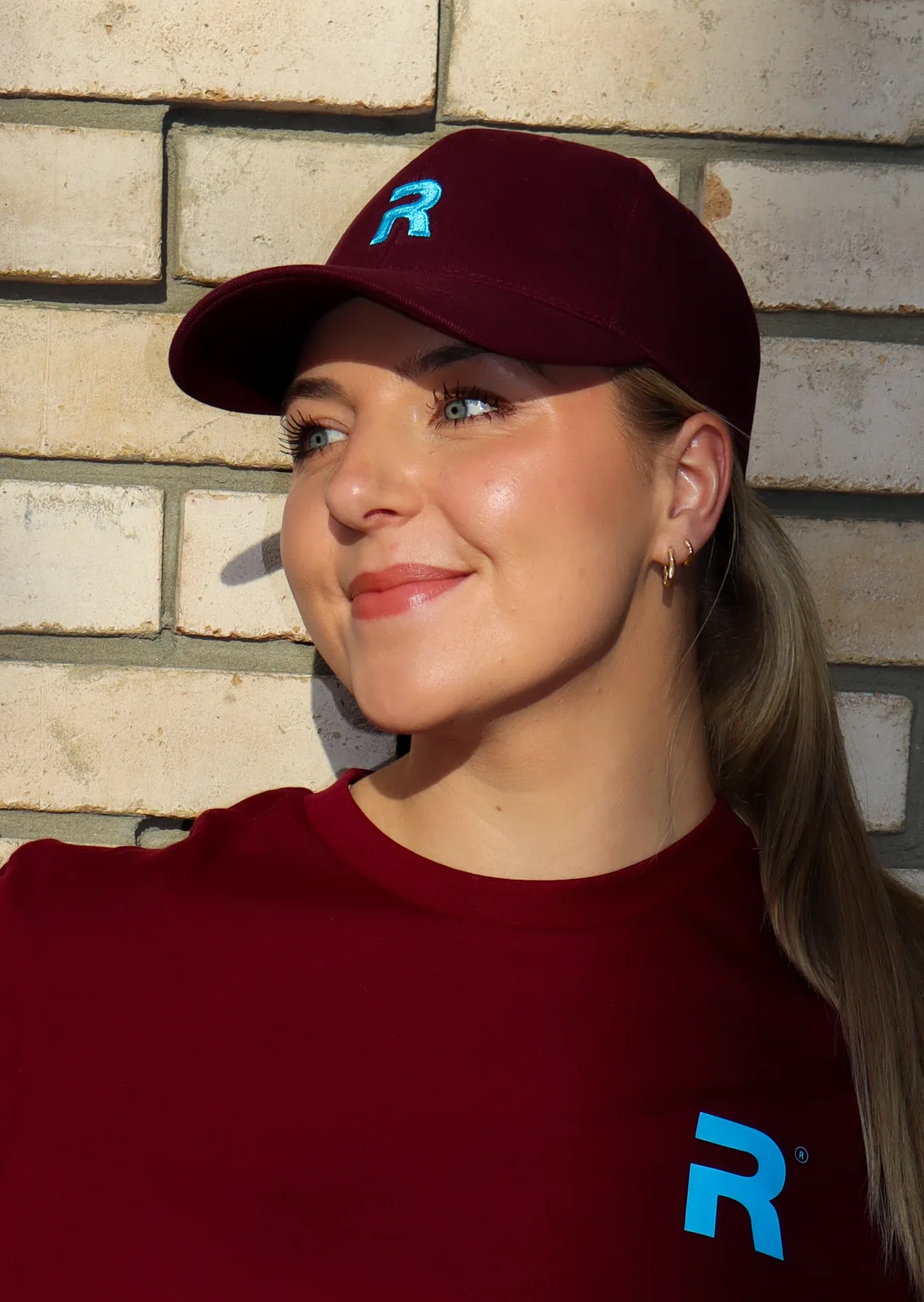 Burgundy RECO HQ cap with the light blue R logo, worn with a matching T-shirt